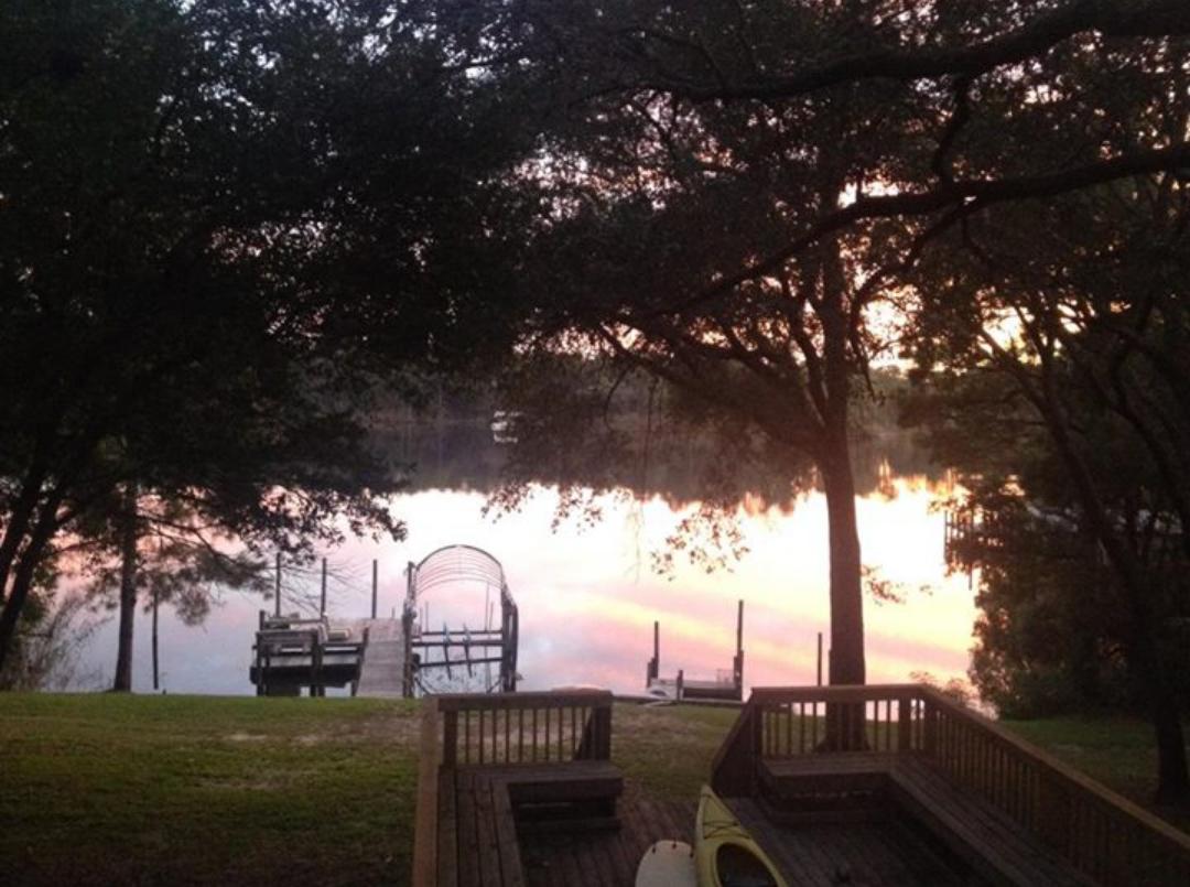 Welcome to your secluded home on the Bayou. Tucked away behind the tree line, your driveway brings you into your own area for utmost privacy. As you approach this home you are greeted with a large covered front patio area. Through the front door is the tiled living room with build-in entertainment center, gas fireplace, and double French doors out to your massive open back deck. This home boasts a flowing open floor plan as the casual dining area is to your left and around the corner is the kitchen with breakfast bar. Gas stove and brand new stainless steel dishwasher with plenty of countertop and cabinet space, perfect layout for entertaining. Your laundry room is off the kitchen separated by a door. On the left wing of the house is the Master Suite with another pair of French doors