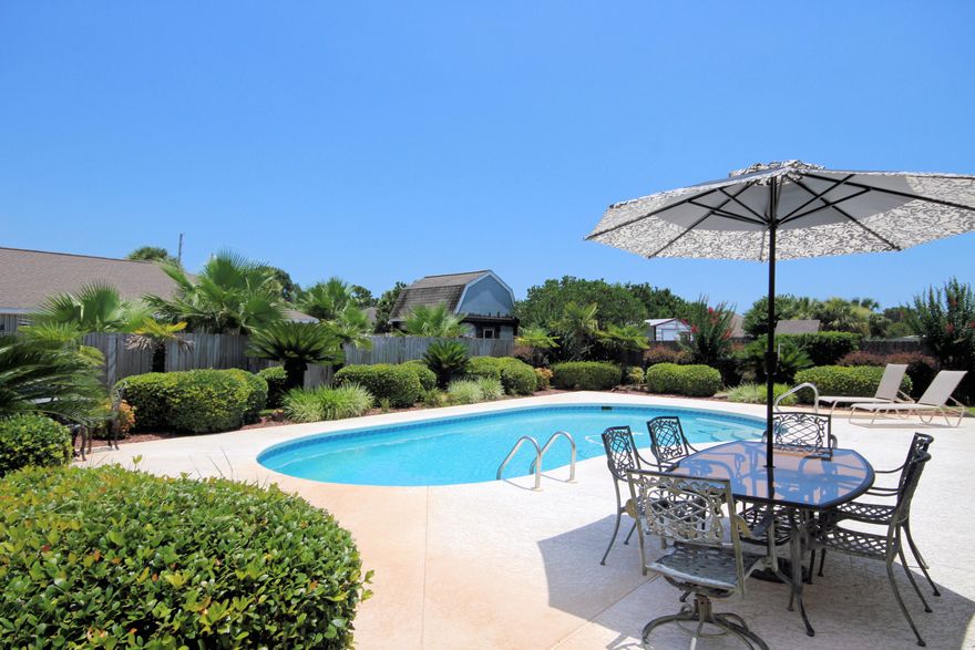 Great POOL, Great Landscaping, Great House! This 4 bedroom 3 bath is located on a cul de sac in East Navarre close to beaches, schools, shopping, military bases, etc. This all brick home also includes hurricane shutters, high wind rated garage door and whole house generator! Step inside and you'll notice easy care tile floors throughout and high ceilings along with a light, bright open floor plan with plenty of storage throughout this home. The split bedroom floor plan includes a large master bedroom with double sinks and walk in closet. In the center of the home is the living room, formal dining, laundry room and eat in kitchen with plenty of cabinets, counter space and pantry. Out back you can enjoy your patio and the low maintenance, salt system, gunite pool in the fenced yard...