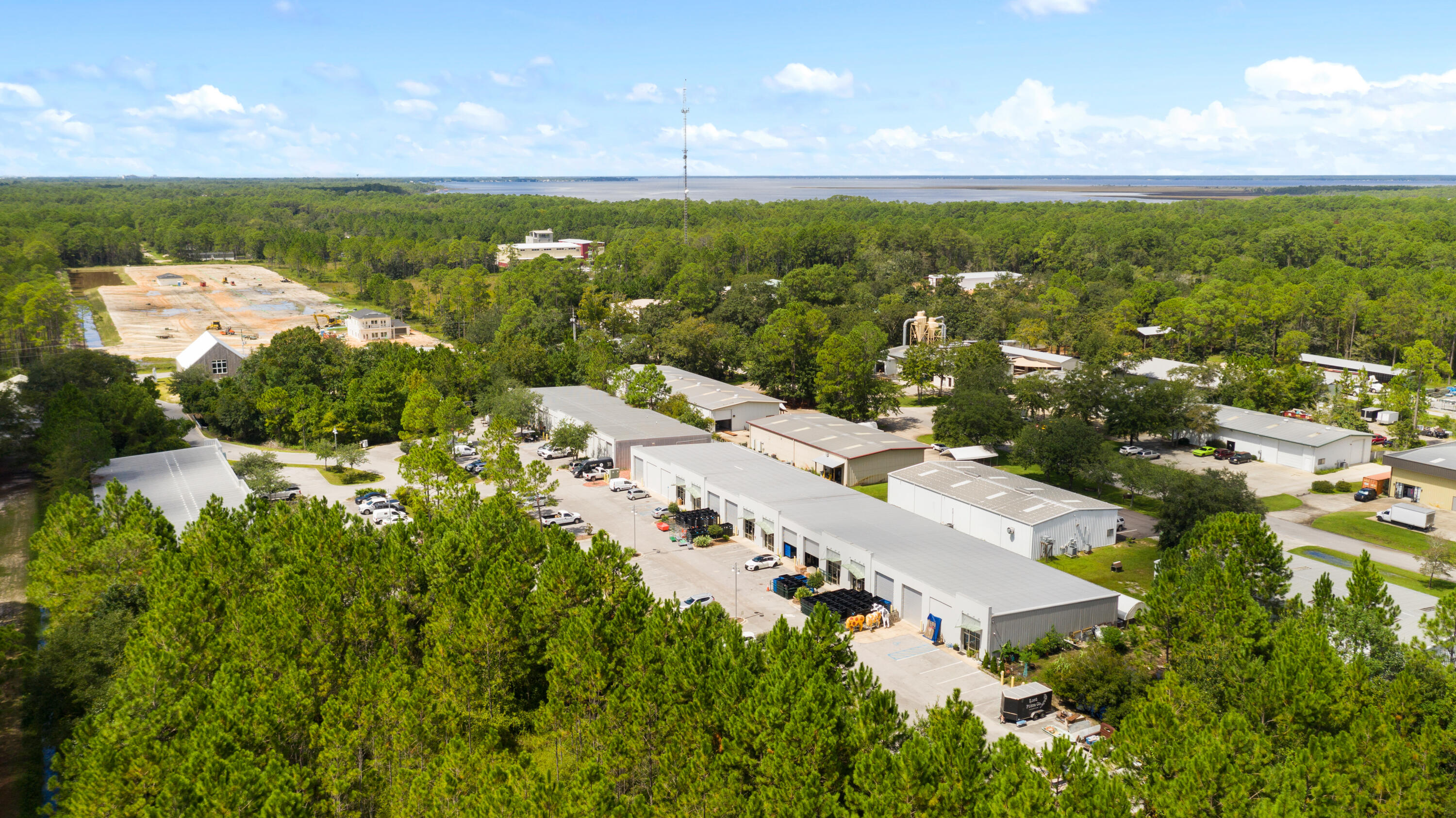 Extremely rare opportunity to own a large light industrial development in Santa Rosa Beach, Florida. Consisting of nearly 22,000 square feet, the property is an assemblage of multiple units. Fully heated and cooled, the floor-plan is approximately 60% office space and 40% warehouse. Features of the build-out include custom entertaining space, multiple fully equipped kitchens, six bathrooms, crafted doors, exposed brick and much more. Offices showcase custom built-in desks, shelves and bookcases. Ample parking is available on-site. All public utilities are available to the site including public water and sewer, gas, electric, and telephone.