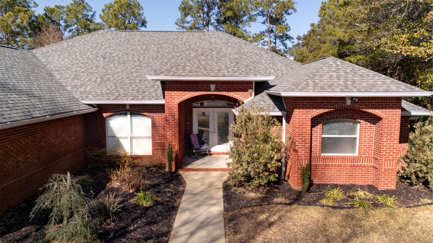 Inviting and peaceful, with 2863 sq ft.this 4 bdrm, 3 ba. home built towards the end of cul-de-sac. Holley by The Sea is a neighborhood of those ranging from a slower lifestyle to a young bustling beginning, you're sure to feel at ease to call this place home. Introducing a fireplace at it's entrance, office area, generous kitchen, roomy 3 car garage w one space designated for a golf cart, his & her vanities, a guest ba connecting the pool deck & a large fenced-in backyard. This features a screened-in patio connecting the pool deck with capacity to cook & entertain while also offering the serenity of the wooded area beyond the fence line. Home is being sold ''AS IS''. Whether you appreciate a classic look or plan for a more modern take, come experience for yourself.  New roof in 2024, both hot water heaters replaced within the past 2 years.  Pre-engineered wood flooring in the front living area, office and master bedroom.  Tiled throughout the rest of the home with exception to the guest bedrooms which have carpet. Buyer(s) are responsible to personally verify all details for property and dimensions. Any information contained in this listing is believed to be accurate but is not guaranteed.