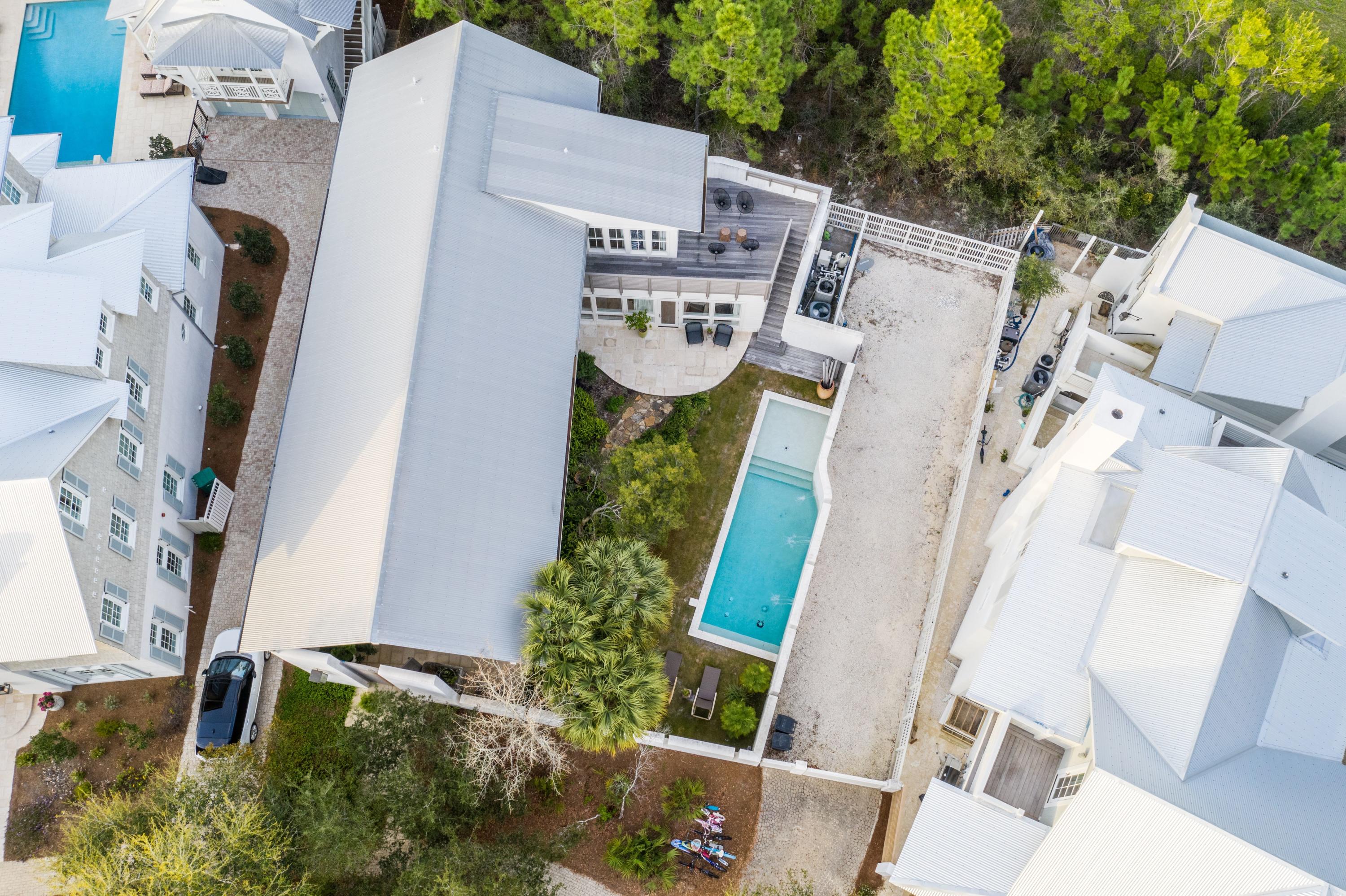 This 4 bedroom 4 bath contemporary beach home designed by Carey McWhorter sits on one of the largest lots in Rosemary Beach and offers a spacious courtyard, pool, patio and covered loggia. Amazing outdoor living space! Ample room to build a carriage house on this home site (current owners have HOA approval on this). The first floor of this home offers an open living area and a soaring 28 foot vaulted and beamed ceiling making for an amazing airy space to have family gatherings or entertain guests. The kitchen has all the finest appliances, stainless steel Dacor gas stove and oven, Dacor microwave, Viking wine cooler, Viking refrigerator, marble counter-tops a modern custom walnut cabinetry. The home offers a very practical utility room with is completed with a Miele washer and dryer