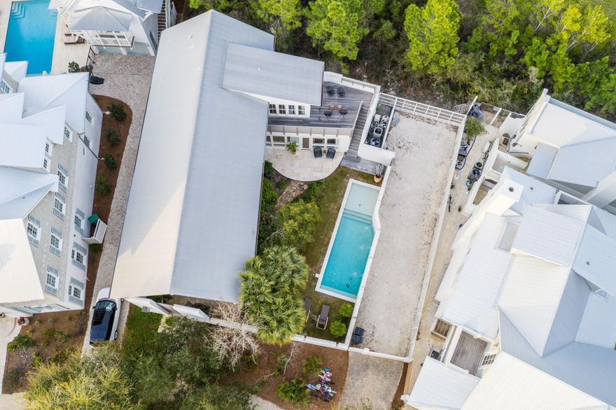 This 4 bedroom 4 bath contemporary beach home designed by Carey McWhorter sits on one of the largest lots in Rosemary Beach and offers a spacious courtyard, pool, patio and covered loggia. Amazing outdoor living space! Ample room to build a carriage house on this home site (current owners have HOA approval on this). The first floor of this home offers an open living area and a soaring  28 foot vaulted and beamed ceiling making for an amazing airy space to have family gatherings or entertain guests. The kitchen has all the finest appliances, stainless steel Dacor gas stove and oven, Dacor microwave, Viking wine cooler, Viking refrigerator, marble counter-tops a modern custom walnut cabinetry.  The home offers a very practical utility room with is completed with a Miele washer and dryer