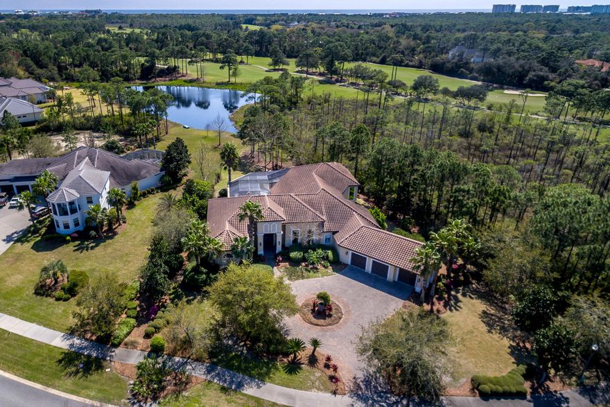 REDUCED! An amazing residence situated on an outstanding lot in Destin's desirable Kelly Plantation! The home's exceptional setting on Kelly Plantation Drive across from the exclusive Waterford neighborhood provides several advantages: it overlooks the attractive Waterford fountain/pond, is easy for guests to locate, offers excellent curb appeal, and is just a short drive from the community's east guarded entry. The lot also adjoins a lovely lake and natural preserve land, providing privacy, beauty, and the sense of being surrounded by nature!This is a home of generous proportions--in terms of indoor and outdoor living space as well as in its architectural design, including high ceilings, dramatic columns, double tray ceilings, oversized windows and doors, and more! The dramatic