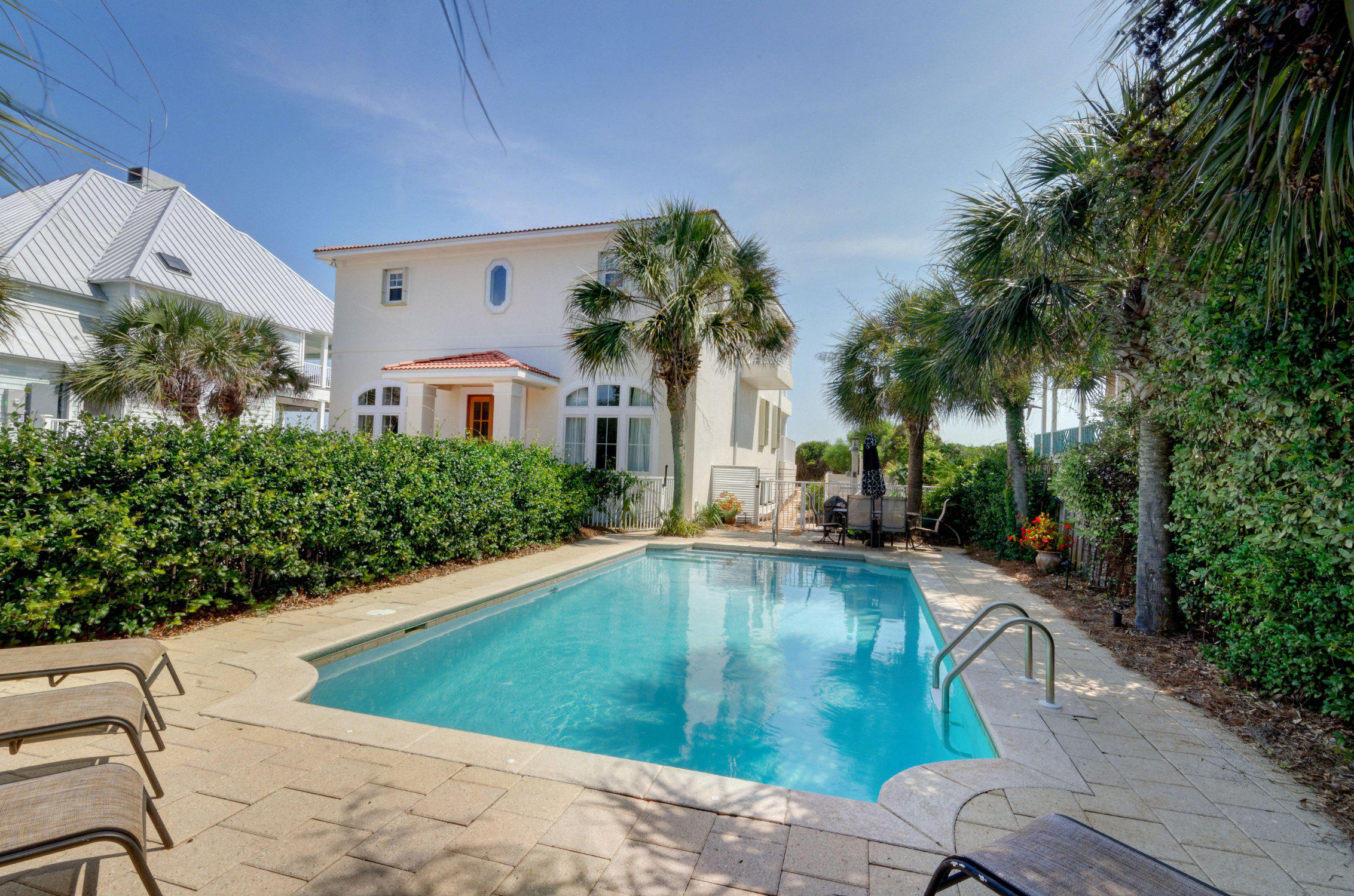 Drastically reduced well below a recent Appraisal! This Gulf Front Pool Home offers stunning Gulf views from the main living area and three Master suites that open onto expansive deep balconies. Recently renovated, thiselevated Beach home is located on a 75 feet of private, pristine beach frontage measuring 395' deep. A seawall was installed to protect the dune. The privacy and abundance of interior and outdoor space combine to make this house the ideal family home or rental investment.The spacious, open floor plan with warm wood floors, crown molding and gas fireplace on the main level is a perfect compliment to the wall of glass windows that offer mesmerizing Gulf views. The gourmet kitchen with glass door cabinets, stainless steel appliances, two refrigerators, icemakerand