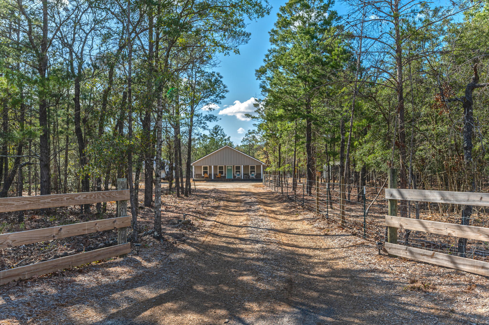 Situated on nearly 5 acres, this 3 bd/2 ba cottage-style home w/ inviting front porch is as good as new! The home is complete with neutral tones and water resistant laminate flooring throughout. Featuring an open floor concept w/ spacious living area, the adjacent kitchen boasts white cabinetry, granite countertops and stainless steel appliances. A spacious master suite w/ dual marble vanities, a very large walk-in closet and oversized marble shower w/ dual shower heads. The guest bedrooms are both a nice size as well. Guest bathroom has tub/shower combo w/ marble surround and marble vanity. The property contains an 18' x 28' pole barn w/ power and 12' x 24' shed w/ power. The property is less than 2.5 miles to I-10 and a convenient commute to both Crestview and DFS! Buyer to verify all