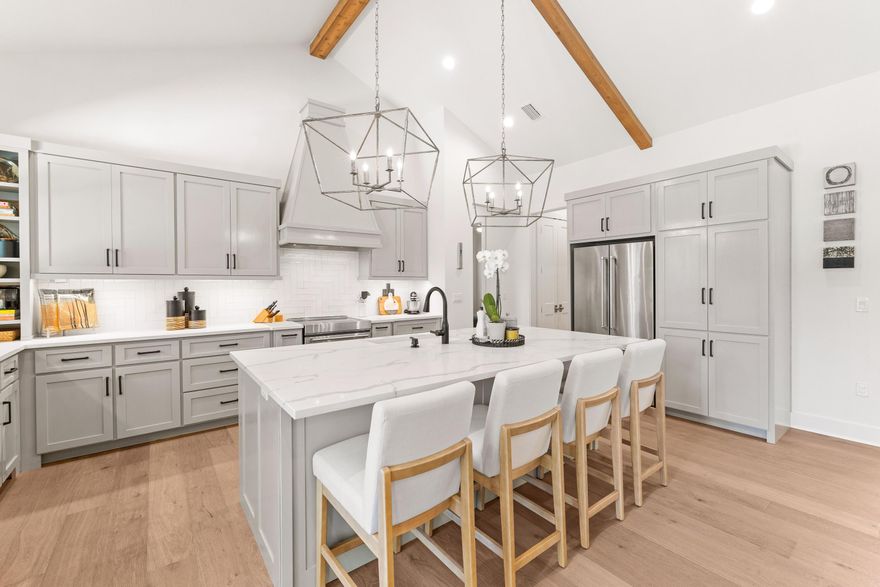 Introducing 51 Morning Sun Court, a beautifully crafted four-bedroom, three-bathroom home that perfectly blends luxury, comfort, and thoughtful design. Built in 2019, this custom single-level residence is located in the sought-after Pelican Bay community--just minutes from Choctawhatchee Bay and a short drive to the stunning beaches of South Walton. Inside, an inviting open floor plan showcases 14-foot cathedral ceilings, a cast stone fireplace, and Pecky cypress accents that bring warmth and character throughout the foyer, kitchen, and dining areas. The gourmet kitchen features quartz countertops, a hooded gas range, KitchenAid appliances, and a spacious breakfast bar, creating the perfect setting for everyday living and entertaining.  The primary suite offers a serene retreat with dual walk-in closets featuring built-ins and a spa-inspired bathroom complete with two vanities, a standalone soaking tub, and a walk-in tiled shower. Three additional guest bedrooms and two full bathrooms, all finished with quartz counters and ceramic tile, provide comfort and privacy for family and guests. A well-appointed laundry room, conveniently located off the garage, includes full countertops, a sink, and charming penny tile flooring. Outside, the fenced backyard offers generous space to create your own outdoor oasis, with room to add a private pool or patio area. Set on a meticulously maintained lot, this property is ideally positioned near top-rated schools, Grand Boulevard, and the Gulf of Mexico. Residents of Pelican Bay enjoy access to a bayfront park with a community dock, picnic area, and pickleball and tennis courtsthe perfect balance of relaxation, recreation, and coastal living.