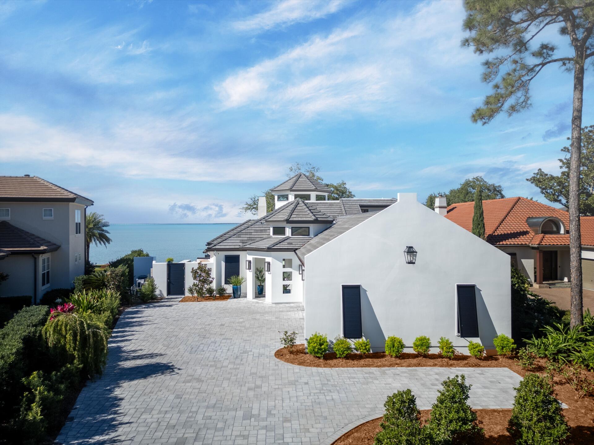 BAYFRONT MASTERPIECE BEHIND THE GATES OF BURNT PINE AT SANDESTIN. HOME HAS UNDERGONE A NEARLY 3 YEAR RENOVATION AND HAS BEEN COMPLETELY REBUILT DOWN TO THE FOUNDATION AND STUDS AND IS LIKE A NEW HOME. NEW TILE ROOF, HURRICANE RESISTANT WINDOWS, STUCCO WALLS, INTERIOR DRYWALL, FLOORING, NEW PLUMBING, LED LIGHTING & LIGHT FIXTURES, DUCTS, FURNACES, AND HVAC'S, POOL, SEAWALL AND DOCK. SMART HOME is 4333 SQ. FT. 4 BEDROOM AND 4 FULL BATHS AND 2 HALF BATHS. KITCHEN HAS TOP OF THE LINE APPLIANCES, PANTRY, COFFEE BAR. MEDIA ROOM WITH 120' PROJECTION TV, 12 FT. SLIDING GLASS DOORS OPEN TO THE BAY AND OUTDOOR KITCHEN AND FIREPIT. FIRST FLOOR PRIVATE MAIN SUITE HAS HIS & HER CLOSETS AND BATHROOM HAS A WET ROOM FOR THE SHOWER & TUB. ALL BEDROOMS HAVE THEIR OWN FULL BATH. HOME HAS IT ALL!!!