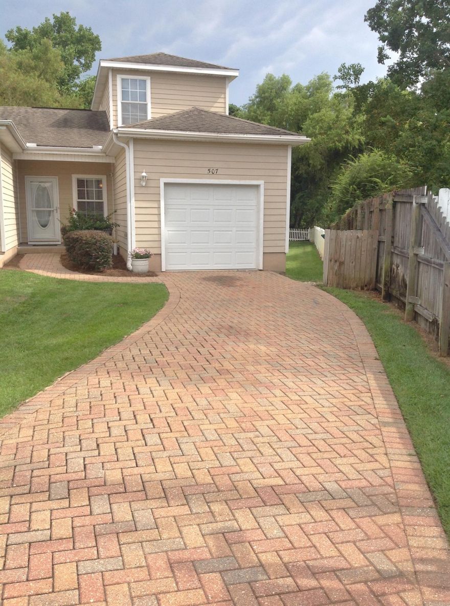 You're going to fall in love with this spacious, end unit Town home with garage and extended pavered driveway for additional guest parking. Walking distance to the Bayou! The archways create a beautiful flow from room to room. The tiled entry way, leads to the tiled dining area and kitchen with stainless steel GE appliances, and newer Whirlpool dishwasher. There are granite counter tops, rich wood cabinets and a pantry. Living room has sliding glass doors to the screened in porch, perfect for relaxing, or grilling out. The 1st floor master bedroom also has doors to the porch. Master bath has beautifully done subway tile shower with glass tiled accent and new vanity. All carpet was replaced with hand scraped, hickory laminate flooring, including the stairs. 2 additional large bedrooms and