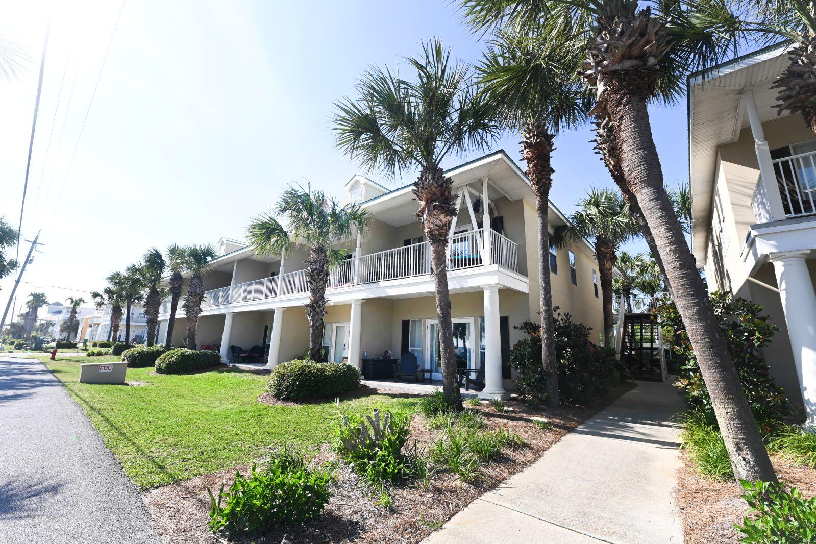 Here's a gem in Caribbean Dunes located in much sought after beach area of Crystal Beach, in the heart of Destin, steps from the sand. Well maintained end unit has views of the gulf and is a fully furnished Turn Key rental. Plenty of bookings already in place about $45k already on the books for 2022. Low Density building with only two floors and 12 units in this building, a community pool, hot tub, and clubhouse, two public beach accesses, including The Shore at Crystal Beach Park offering beach pavilion, bath house, lifeguard, and full beach service. Also includes deeded beach access. Rarely do corner units come available. Brand new AC system installed in 2022, custom built headboard in the master, relaxing porch swing/bed on the balcony, crown molding,