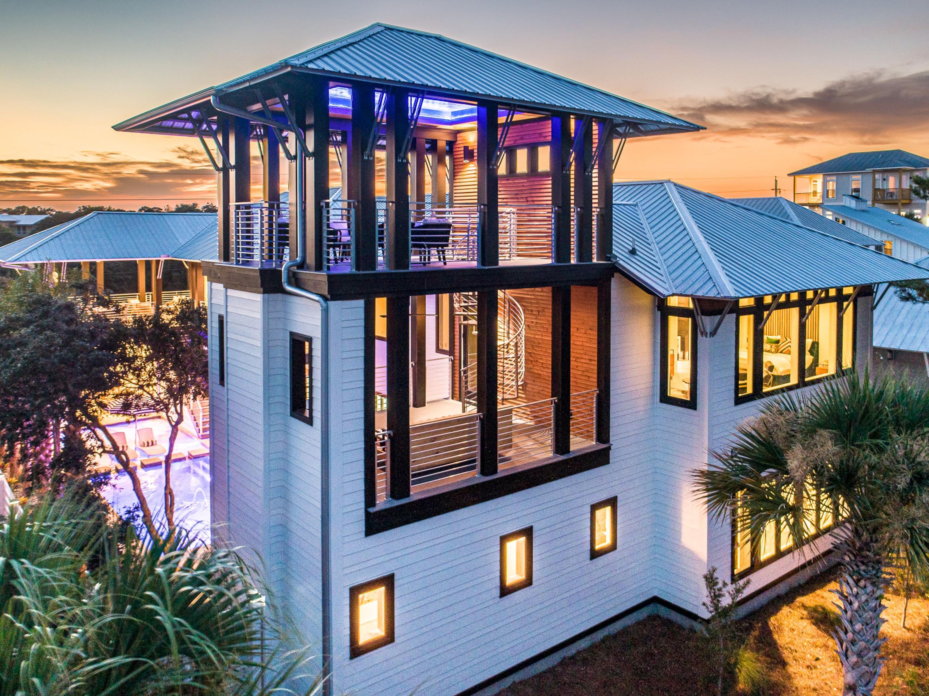 This iconic Dune Allen residence is equal parts private coastal retreat and enviable vacation destination. The hone blends architectural artistry with professionally designed interiors to create a modern masterpiece that balances rustic warmth with contemporary style. Inside, a lavish kitchen with Wolf appliances and a 12-ft. Luke Langford dining table anchors the open floor plan, while a dramatic concrete fireplace adds character to the living space. Large windows flood every corner with natural light and frame tranquil views. Five suites, two bunk rooms, two laundry rooms, and multiple common areas make the home ideal for large family gatherings or group getaways. Step outside to a private courtyard where the pool and spa are enhanced by fountains, a sun shelf, and swim-up seating. Porches on every level invite moments of relaxation, from a grilling porch off the kitchen to a cozy sleeping porch with fireplace. The watchtower lounge crowns the home with sweeping panoramas. A two-car garage with climate-controlled storage adds convenience for long stays.
Perfect for entertaining or unwinding, this home also shines as a vacation rental, sleeping up to 22 guests. The outdoor oasis features a summer kitchen with built-in grill, poolside smart TV, mini fridge, table tennis, spa and a pool with optional heater. Just a two-minute stroll to the beach, owners and guests alike will enjoy parking, services, and easy access to the best of 30A.
Sold fully furnished, including curated works by Madison Stone, Laurel Galloney, and Marisa Silver, this property offers a rare chance to own a residence featured in both VIE Magazine and its HOME coffee table book, designed to deliver both luxurious private living and strong rental potential.
This iconic Dune Allen residence is equal parts private coastal retreat and enviable vacation destination. The hone blends architectural artistry with professionally designed interiors to create a modern masterpiece that balances rustic warmth with contemporary style. Inside, a lavish kitchen with Wolf appliances and a 12-ft. Luke Langford dining table anchors the open floor plan, while a dramatic concrete fireplace adds character to the living space. Large windows flood every corner with natural light and frame tranquil views. Five suites, two bunk rooms, two laundry rooms, and multiple common areas make the home ideal for large family gatherings or group getaways.
Just steps away, the Dune Allen beach access offers over 220 feet of pristine beachfront with restrooms for convenience and a lifeguard station for added peace of mind.