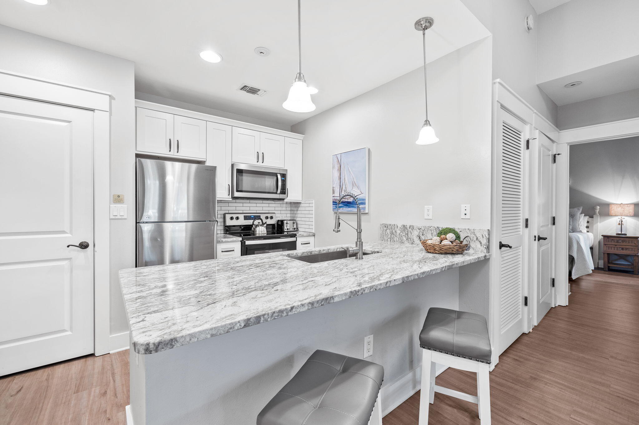 Discover the ultimate beach retreat in this 2 bed 2 ba lockout unit at the Village of Baytowne Wharf. Enjoy private garage parking and multiple upgrades, including stunning granite countertops, white shaker cabinets, luxury plank flooring, and new appliances and furnishings. With convenient first level living, this spacious corner unit boasts a private fenced yard offering easy entry to stores, restaurants, and entertainment and an easy stroll to the marina and tennis courts. Access the amenity level effortlessly, complete with a fitness center, swimming pools, and outdoor kitchen. This property offers a multitude of possibilities, making it a highly versatile option for buyers seeking a second home, vacation property, or investment opportunity. Projections reflect a Rental Machine!