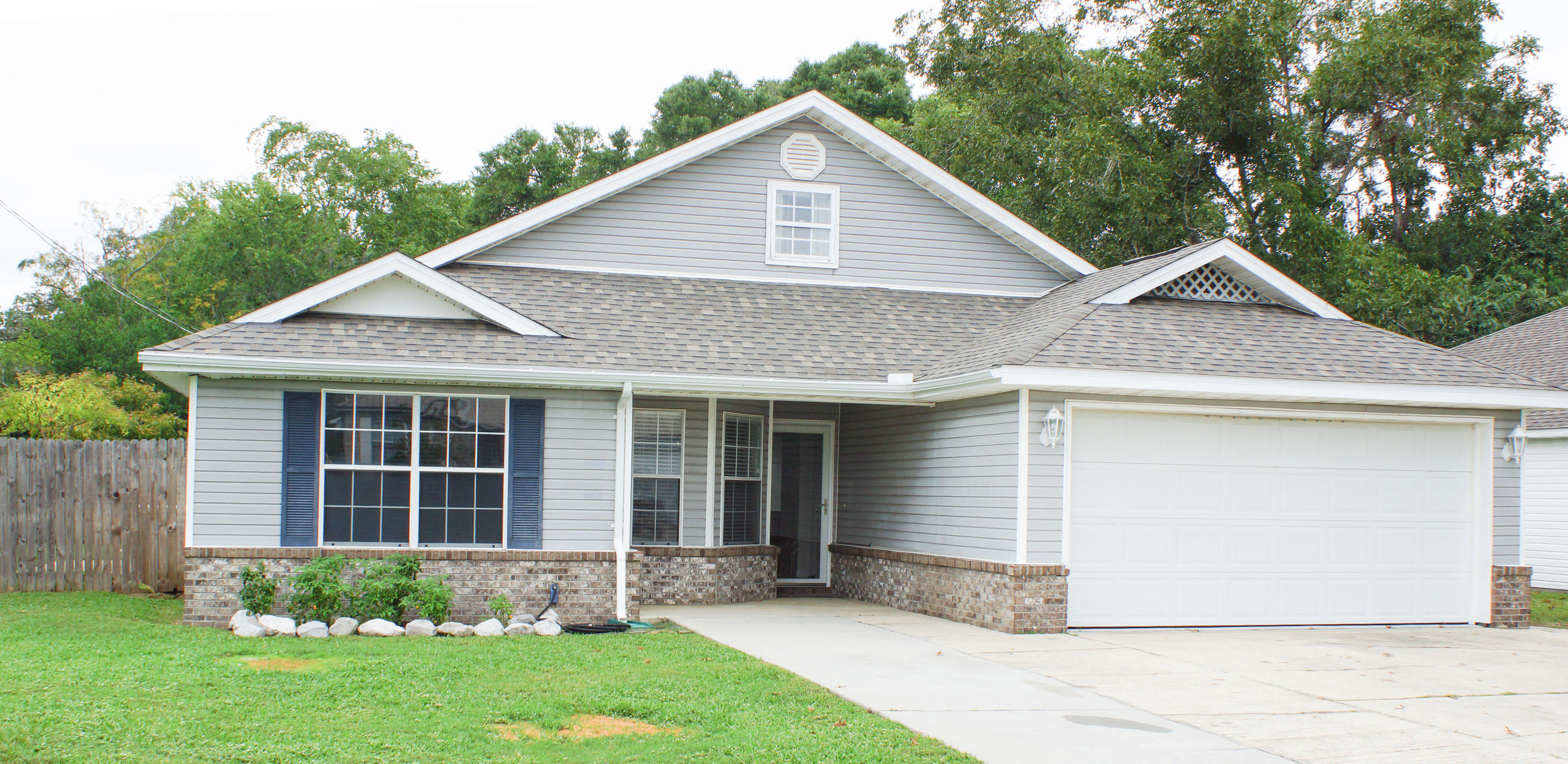 CLOSE TO BASES AND BEACHES--Lovely 3 bedroom, 2 bathroom split floor plan home on a corner lot. Emily Circle is tucked away but close to Lowe's, Walmart and everything else along Beal Parkway. The large living room features a cathedral ceiling, wood flooring and brick fireplace with mantle. The kitchen has a cozy dining area with bay window, and there is a small laundry room off the kitchen. A side door leads to the fenced yard. The large master bedroom has a trey ceiling and a spacious master bath with walk in tile shower, his and her closets and double vanity. The two other bedrooms share a full bathroom. Pull down stairs lead to finished attic. Oversized two car garage plus a large driveway. Kitchen updated in 2009 and new roof in 2014.