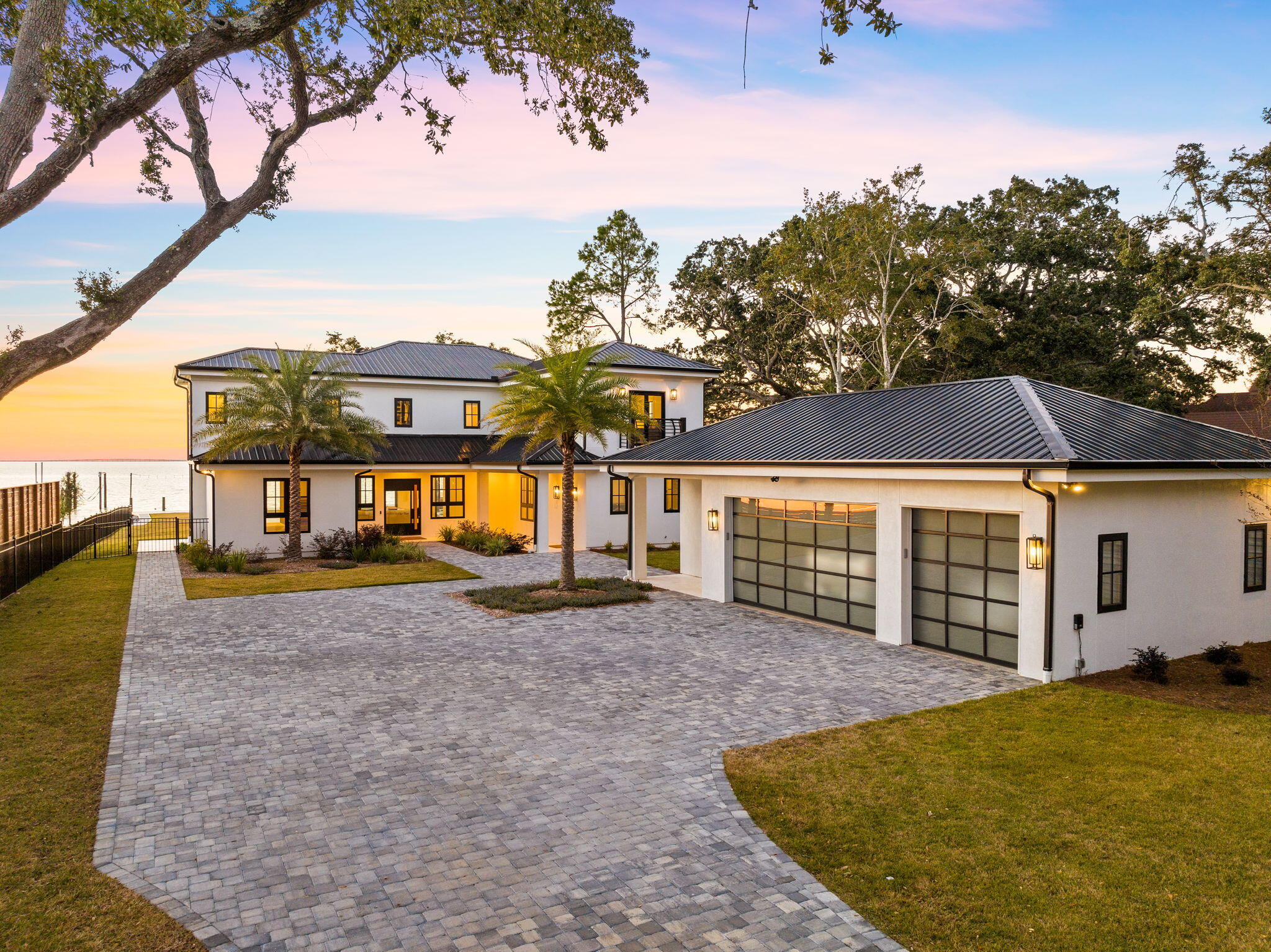 Situated on an oversized bay front homesite, 253 Driftwood Point Drive is a stunning estate with endless views and forever sunsets! This fabulous western facing property boasts year-round panoramic spectacular sunsets across the Choctawhatchee Bay. As you traverse the shaded 300' driveway, you will be drawn to this newly renovated home. The water will capture your attention as you enter through the custom designed pivoting front entrance.  The uniqueness of the property shape offers 180-degree bay views from most all rooms of the home.  The beautiful well-thought-out floor-plan showcases 4-bedrooms and 4-bathrooms of fantastic living. Recently under-gone a full renovation to the studs, the property offers the same amenities, features, and fixtures of any new