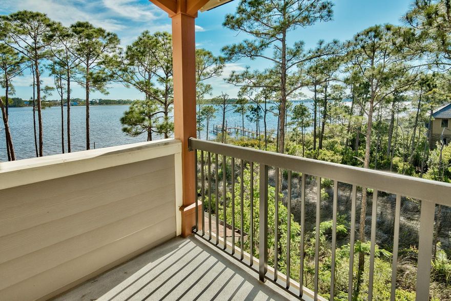 Lakeside Lodges at Prospect Point is the most sought after location at Wild Heron, a 750 acre award winning planned community on Lake Powell, a rare coastal dune lake. Wild Heron's world class amenities include a seasonal shuttle to the area's stunning beaches, one of Florida's top rated golf courses, the Greg Norman-designed Shark's Tooth Golf Club, an array of community activities, dock and boathouse, picnic and play areas, nature trails, fully equipped fitness center, covered parking, and private pool and whirlpool for condominium owners, A staffed gatehouse assures privacy and security 24/7. Nestled among the treetops right on Lake Powell, is this stunning, end unit, 4 bedroom, 3.5 bath, condo that boasts gorgeous views of not only Lake Powell but the Gulf of Mexico.