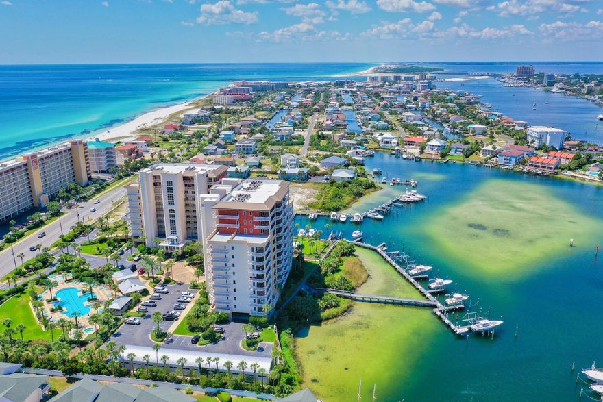Huge PRICE Reduction!! Motivated seller!!  Fabulously furnished and ready for you!  Gorgeous views of the harbor and the gulf of Mexico from the covered large balcony, living area, master bedroom and 2nd bedroom.  Your friends and family will enjoy watching the boat life on the harbor, the Thursday night fireworks over the pass and the astounding wildflife like manatee, dolphins, osprey, wild heron and tarpon.  The kitchen opens to the living area and offers the perfect setting for entertaining friends and family.  Classic neutral colors in flooring and walls aids the relaxing effects of seeing the water wherever you sit or recline. Each bedroom is outfitted with a bathroom for  privacy and ease. Reassuring carpet in the bedrooms and hardy tile in the bathrooms and living area balance comfort and convenience.  Harbor Landing offers the best of Destin!  With private deeded beach access to the sugar white sand beaches of the emerald green gulf of Mexico and the opportunity to get on a boat from your backyard and go gulf and bay fishing or cruising to crab island, you won't find a more convenient location in all of Florida.  The gated community of Harbor Landing offers two pools, a workout center, deeded beach access and a private marina.  