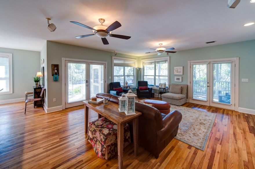 Close to the beach and community pool, this 3 bed, 2 bath home covers Eighteen 34 square feet. The upper level sun deck has dual aspects and serene treetop vistas while the lower covered porch has extensive space for dining and relaxing. The open plan living space is the hub of the home. The L shaped breakfast bar provides casual dining space for the entire family as an alternative to the formal dining nook. Two bedrooms complete the first floor space while the second floor is dedicated to a grand Master Suite. The light pine flooring continues from the ground floor while floor-to-ceiling windows add ample natural light.