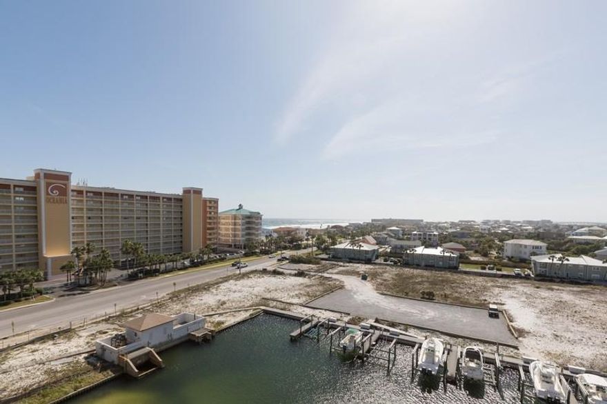 Overlooking the Destin Harbor and offering great Gulf views and spectacular sunsets  at Harbor Landing.  Spacious two bedroom/two bath unit, nicely appointed and perfect as your primary residence, second home or vacation getaway. Large balcony accessible from living area and master is the perfect spot to relax, take in a sunset or watch the fireworks on the Harbor.  Master features dual closets, walk-in shower, Jacuzzi tub. 
Kitchen offers plenty of counterspace and cabinetry, Laundry/Utility room off the kitchen with full-sized washer and dryer, separate owner's/storage closet. Conveys with assigned parking space in garage. Gated resort with community pool and a separate owners only pool and hot tub, community room, fitness center, gas grills and picnic area,deeded beach access.