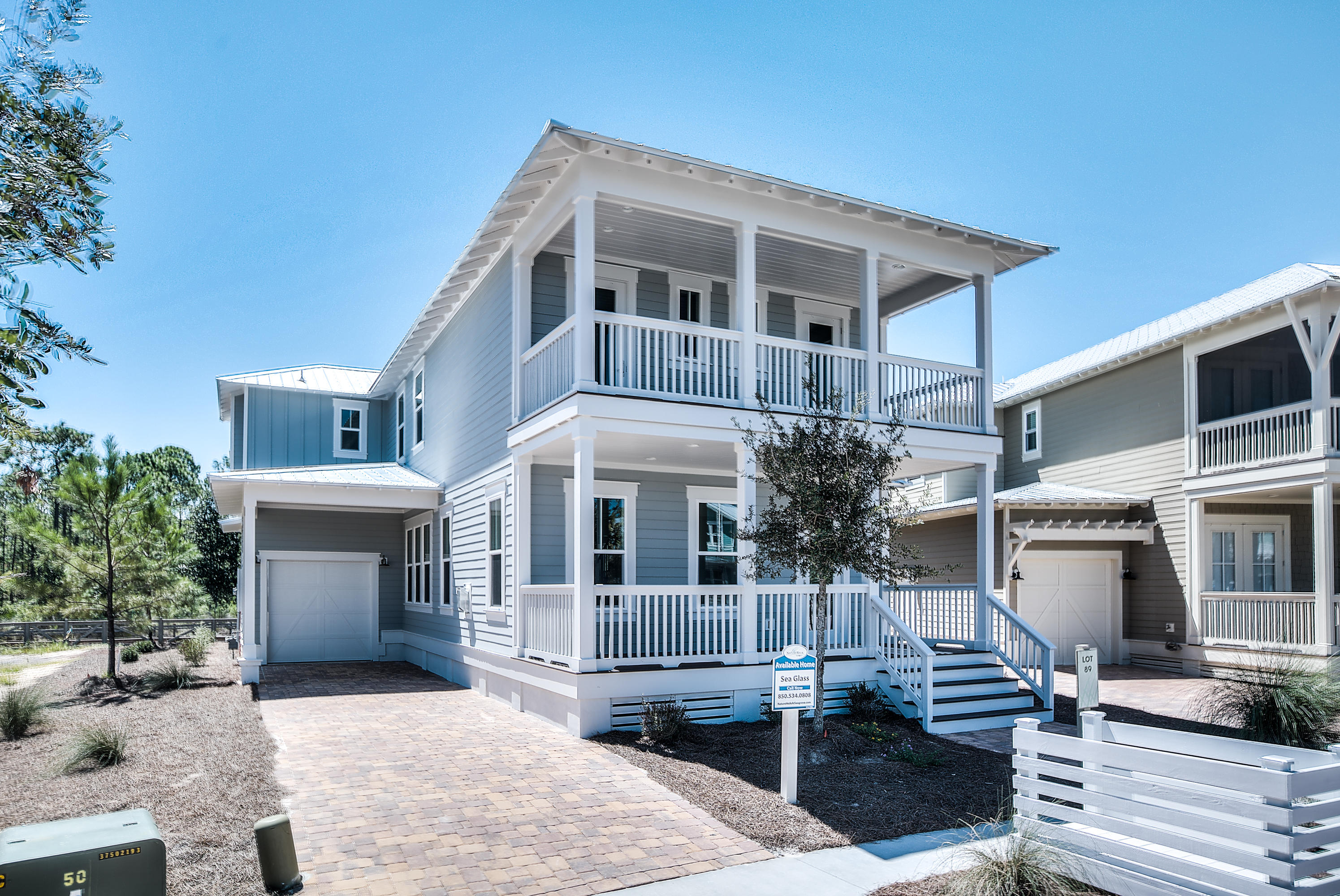 Our very popular Sea Glass floor plan home is almost complete! Ideal location close to The Gathering Place- the community pool. This home is also on one of the BEST homesites in the community with privacy/ pond views from the 2 front porches and 2 back porches! This beauty has a long driveway for parking, carport, and extended garage for all your beach toys! Perfect home for entertaining with huge open living room with fireplace and white beams. Kitchen also has a cozy keeping room area and large covered porch overlooking the pond behind the home. Kitchen finishes include white Shrock quality cabinets with soft close drawers, huge island with wine rack and bookcase on the ends, carerra marble countertops, white subway tile backsplash and GE Caf appliances including gas cooktop (GE monogram hood). Relaxing master suite with covered porch also overlooking pond and preserve behind the home. Master suite bath also has gorgeous grey tile and a stunning free standing tub! Your family will have a blast at the amenity-rich Gathering Place- complete with heated lap pool, hot tub, zero entry pool, fire pit, grills, and much more! Newly added amenities will include more trails throughout, Energi fitness stations, multi-purpose court, pickelball court, and more green space. NatureWalk has a seasonal beach shuttle running to and from the beach and Seaside! We are open 7 days a week, come check out this home and our 3 designer decorated models today.