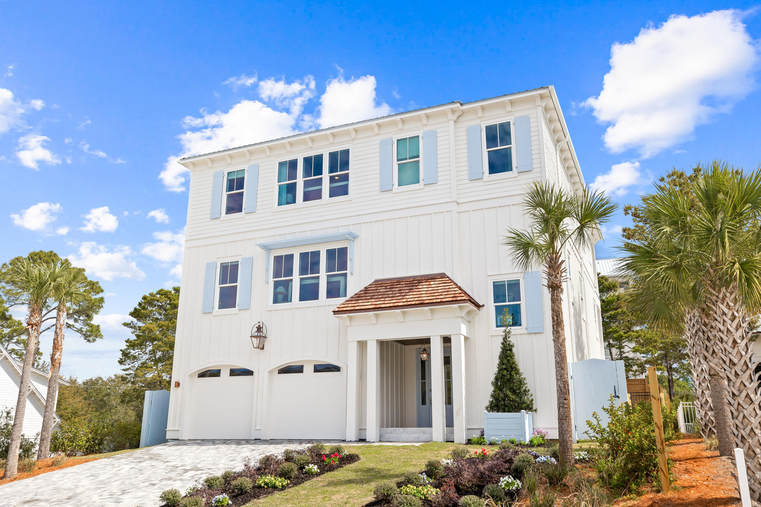 For those dreaming of a beach house beyond the ordinary, take a look at this brand-new, one-of-a-kind custom beauty. Complete with designer wallpaper, feature lighting, handpicked artwork and high-end furnishings by local designer, Apres Sun, it's quite unlike anything else on the market. Every space has been thoughtfully honed to combine European aesthetics with practical functionality. Rising from street level, this three-story home is fronted by a wide paved driveway and lawns edged with color-filled flower beds. A two-car garage accommodates vehicles, bikes and beach toys, while a covered porch frames the grand entrance. Explore the spacious pool room with sitting area, the laundry, bunk room and the pool bathroom on this level. On the second floor, wood flooring perfectly contrasts the light stone archway, which separates the dining area and the comfortable sitting room from the chef's kitchen. Imagine entertaining and memory-making with family and friends in this attractive space. A kitchen island provides seating for snacks and everyday mealtimes. White-washed walls, stainless steel appliances and veined quartz countertops enhance every inch of this enviable chef's domain. A butler's pantry and a custom hood over the range are just some of the added delights. A half bathroom and the first of two master suites complete this level. You'll want to check out the spacious walk-in closet and the stunning master bathroom with custom tile.
The third-floor master suite is a peaceful sanctuary of tranquility. It includes a custom walk-in closet and a master bath with accent wallpaper above the twin vanity. The covered porch is perfect for enjoying private moments of relaxation at the start and end of each day. A cozy sitting area, laundry, and three additional bedrooms complete the generous accommodations. The loft is cleverly used as an additional TV area with a beverage refrigerator and bar for guests to help themselves to an array of drinks and snacks. Bathrooms have been individually designed using stylish tile and frameless glass shower doors.
Outdoors, the rear fenced yard is centered on a contemporary heated pool complete with a tanning shelf and visual water jets. The pool view can be enjoyed from multiple balconies and outdoor relaxation areas. A lengthy covered gazebo provides the perfect place to unwind or dine with friends. For morning walks, stroll along the nearby white sandy beach and watch diving pelicans and playful dolphins in the beautiful gulf waters. Three beach access points and a nearby golf course create a retreat that's a coastal paradise beyond compare. Hop on bicycles, and in just four minutes, you can be browsing the shops and enjoying the live entertainment and restaurants at Gulf Place. Combining exceptional design with high-end finishes and a prime location, this unique residence provides a rare opportunity to experience 30A living at its very best.