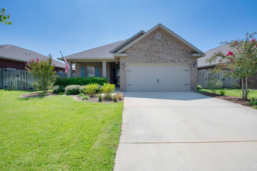 Step inside to find tile flooring and modern grey paint throughout the main living area. The laundry room just past the foyer has plenty of storage space. Beyond that awaits the open Living/Dining/Kitchen areas perfect for entertaining friends and family. The kitchen features granite counter tops and custom cabinet and pantry organizers. 2 spare bedrooms to the left towards the front of the home with their own bathroom with subway tile around a shower/tub combo. The high ceiling in the master bedroom allows for plenty of natural light. In the master bath you'll see a large walk-in closet, dual vanity, and garden tub with separate shower. Spend your days relaxing outside on the covered patio with the privacy of the fenced in backyard. Schedule a showing today and let us welcome you home!