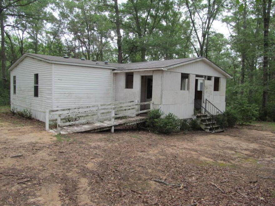 REO. 3 bedroom 2 bathroom mobile home located on 1 acre! Home needs TLC. Property is located on a paved road and features a detached carport. Call today to schedule your tour. Property sold 'as-is.''