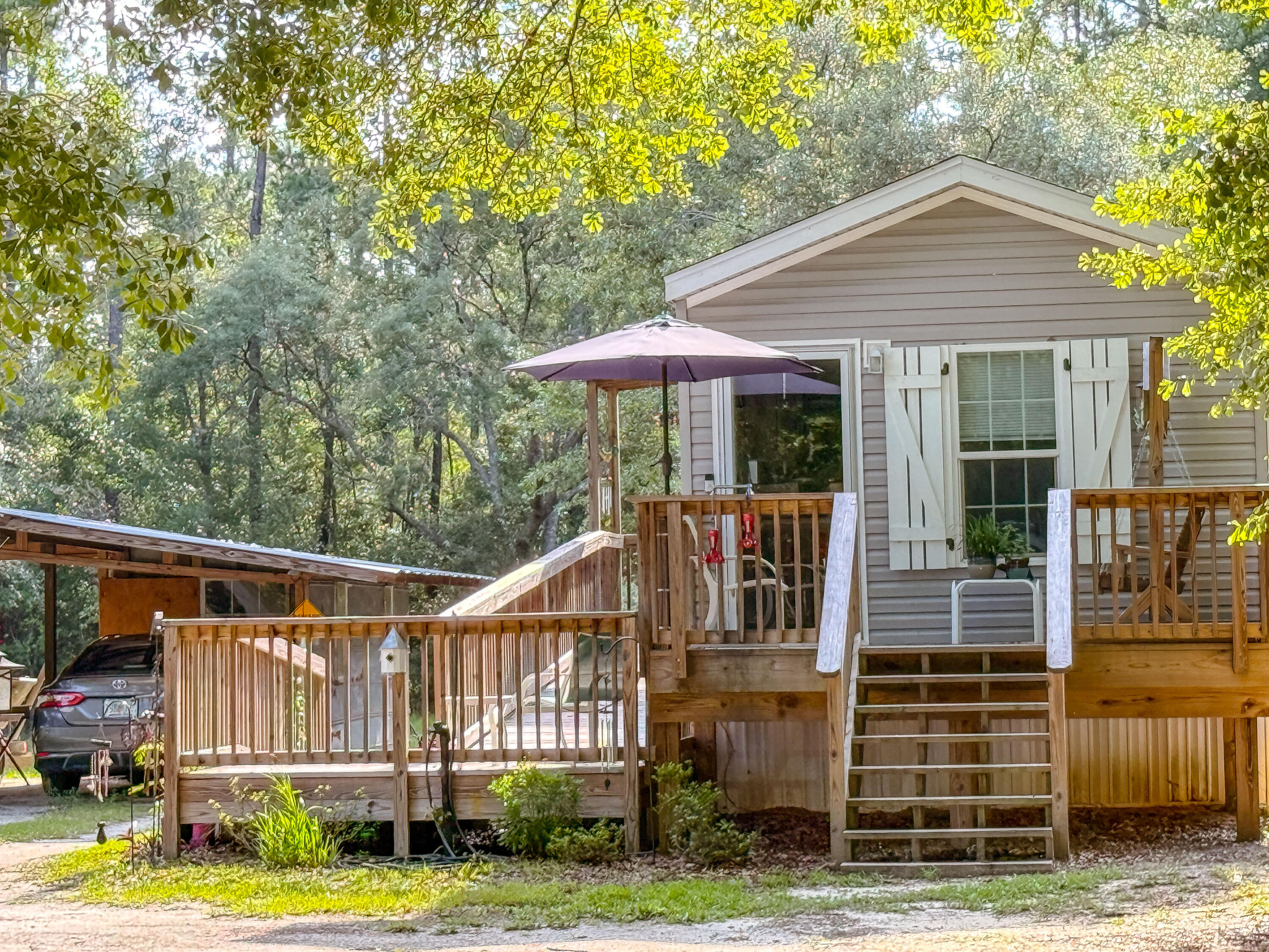 Charming Tiny Home on Over an Acre - Escape to peaceful living near Black Creek with this 1 bed, 1 bath tiny home built in 2020. Set on over an acre with no HOA, flood zone X, this property offers a wheelchair-accessible ramp, city water, a full-size septic tank, and plenty of room to expand--including the ability to build your dream main home. Enjoy outdoor living with an above-ground pool perfect for kids and a spacious yard for play or relaxing under the stars. Just 20 minutes from the white-sand beaches of 30A and minutes to Grady Brown Park and Black Creek boat ramps, this location offers the best of both worlds--quiet country living with easy access to the bay and beach. Bonus: there's potential to purchase a new travel trailer and storage bldg!