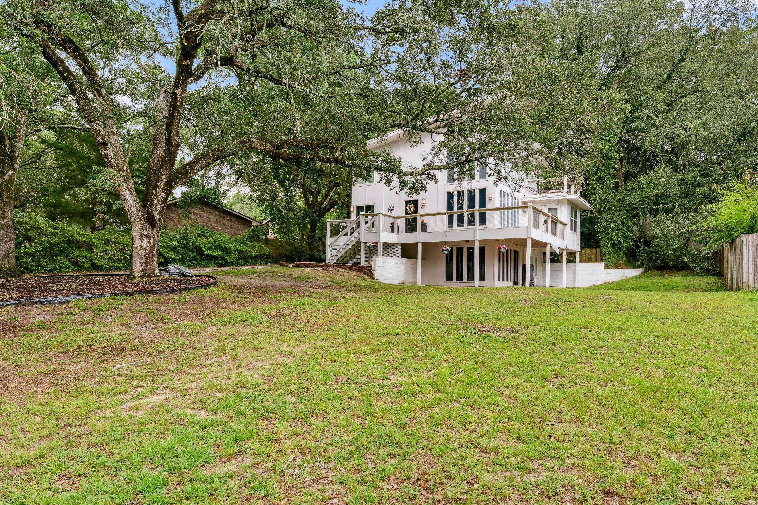 3.75% assumable mortgage to qualified buyers. This is quite possibly one of the most beautiful and uniquely designed homes in theNiceville area. Let all the Florida sunshine come in through the floor to ceiling windows and shine on the golden bamboo flooring (newer). Whetheryou enjoy entertaining guests or cooking for one, you will be pleased with the open concept kitchen with granite counter tops and an abundance ofcabinets. The siding is made of sturdy fiber cement siding and the home has multiple levels of balconies, decking and covered patios, surroundedby beautiful mature trees, peek-a-boo water views & fenced back yard with a large workshop. Bottom level has a separate entry that could possiblybe used as an apartment or in-laws quarters.
