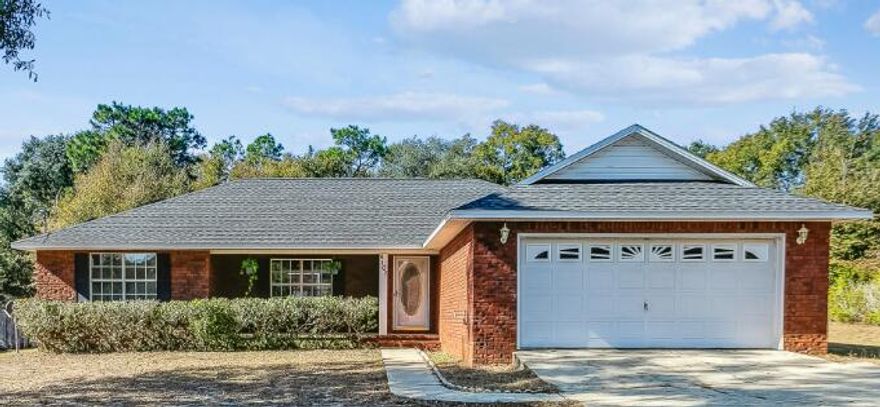 Convenient to I-10, Milton, Hwy 90 and Garcon Point Rd.   This brick 3 bedroom, 2 bathroom home features a split floor plan with luxury vinyl flooring, fresh paint, and lots of natural light throughout. The kitchen has newer stainless appliances, tile flooring, and a breakfast bar looking out over the dining area.  All bedrooms are sizeable and have ample closet space. This property hosts a HUGE workshop in the backyard with storage cabinets, shelving, two garage doors and power.  A privacy and chain link fence surrounds the expansive backyard with plenty of room for a boat/RV/trailer storage, playset or pool. Solar panels will be paid off at closing with an acceptable offer.  No HOA and move in ready for you to make this your new home!