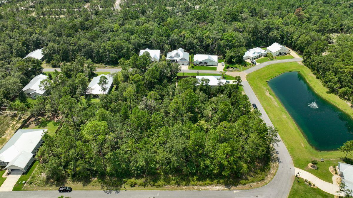 Beautiful wooded lot in Bear Creek Cottages, one of Freeport's most desirable communities. Conveniently positioned just north of the bay, this is the perfect spot for your primary or second home located minutes from schools, shopping, beaches and golf. Bear Creek features a variety of amenities for owners' of every generation to enjoy including a community pool and playground, as well as tennis, basketball, and pickleball courts. Terrific opportunity that's priced to sell.