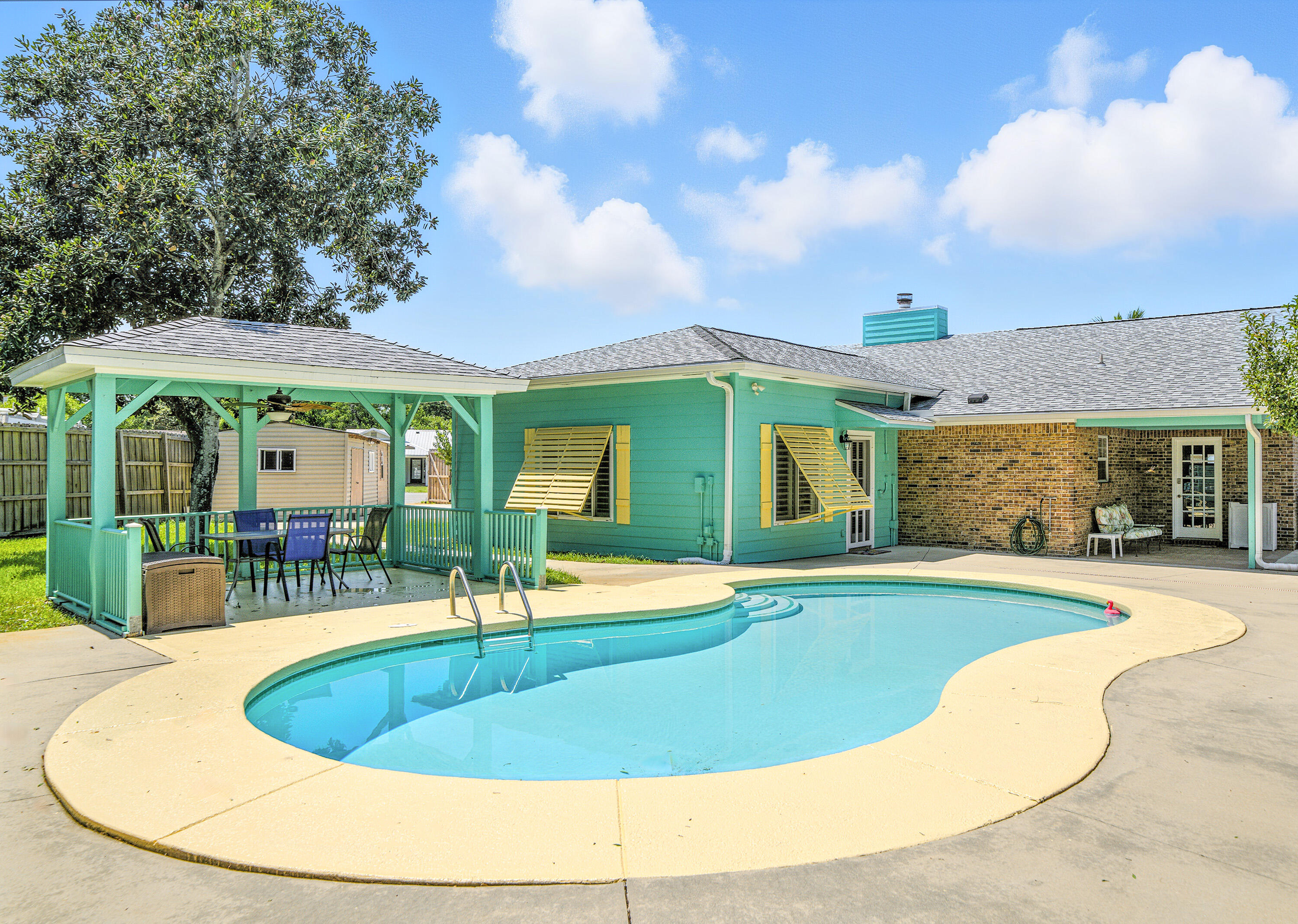 Discover this rare find in the heart of Destin! Tucked away on a quiet cul-de-sac, this 3 bed, 2 bath home offers 2,077 sqft of living space on a generous .32 acre lot. Built for both comfort & convenience, it features gated BOAT & RV parking w/ hookups, a whole-home generator w/ designated propane tank and two exterior shops; ideal for hobbies, storage, or extra workspace. Enjoy Florida living at its best with a sparkling salt/gunite pool, poolside gazebo, producing citrus & fruit trees, an 8ft privacy fenced backyard! Inside, you'll find a functional layout with timeless character, freshly painted and ready to make your own. Built in 1981 and lovingly maintained, this property combines central Destin living with privacy & practicality! Schedule your tour today!