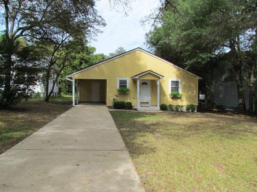 This cute Florida cottage is situated on a large lot close to shopping, bases and the college. Owner will install a NEW ROOF prior to closing with a full price offer. You'll have plenty of parking in the driveway to accommodate cars, boats, etc. From the entryway you'll see the nice open great room with vaulted ceilings, skylights and a sliding glass door leading to the deck. The kitchen has wood cabinets with open shelving on the top (no cabinet doors) and newer appliances. The master bedroom has room for a king size bed and also has an ensuite bath with large tub.  Both bedrooms are good sized. Enjoy the private natural setting in the fully fenced backyard. Schedule your showing today.