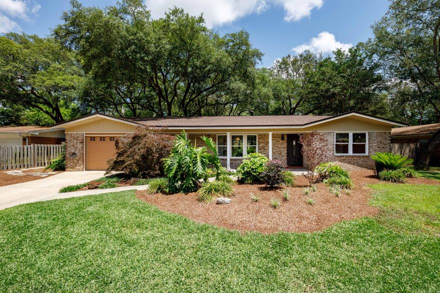 New Price!!  Beautifully renovated Kenwood home! All it needs is for you to move in! Enjoy your own park-like backyard oasis. Under a canopy of oaks, surrounded by lush landscaping, bricked walkways lead you to the covered deck, covered grilling platform, fire pit, classic picnic table.... even a covered loveseat swing.  Shop or storage space in the very cool gambrel shed (15' x 12') with extra 2nd floor storage. Check out all the NEW: roof '23, AC '24, impact windows '24, '25, complete rewire '23, flooring '25. Recently remodeled kitchen - rich classic colors w/granite counters, SS appliances (incl. refrigerator!) & soft-close cabinets (lots of drawers!) Many extras: crown molding, primary bedroom w/private access to sun room, even granite window sills! Don't let this one get away!
