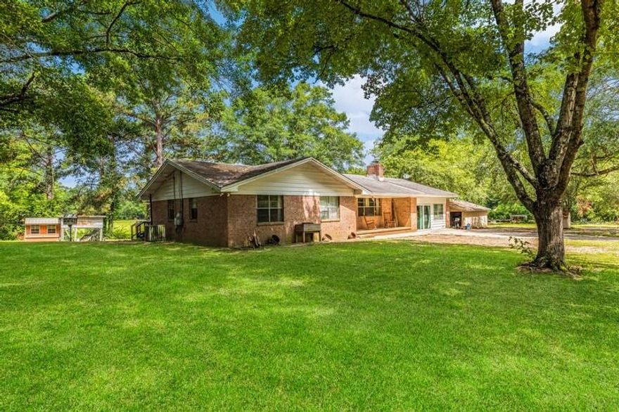 This incredible 10.15 acre property, offers a brick home with a metal roof and a cozy wood-burning fireplace. Fall in love with all the gorgeous old oaks, the 365' of beautiful meandering creek, a workshop with power and 50A RV service, chickens who call this place home and even a few friendly deer. It's your own little slice of heaven! You'll find it fully fenced and cross-fenced. The home received a makeover in 2020, with new flooring and wiring throughout. The kitchen, & dining also underwent a complete remodel (down to the studs) and the master bath just received a facelift, too. At the back of the pasture, you'll find a working well, separate power connection and septic system along with a 25x35+/- slab and disassembled Red Iron Steel Metal frame. giving you some options, there.