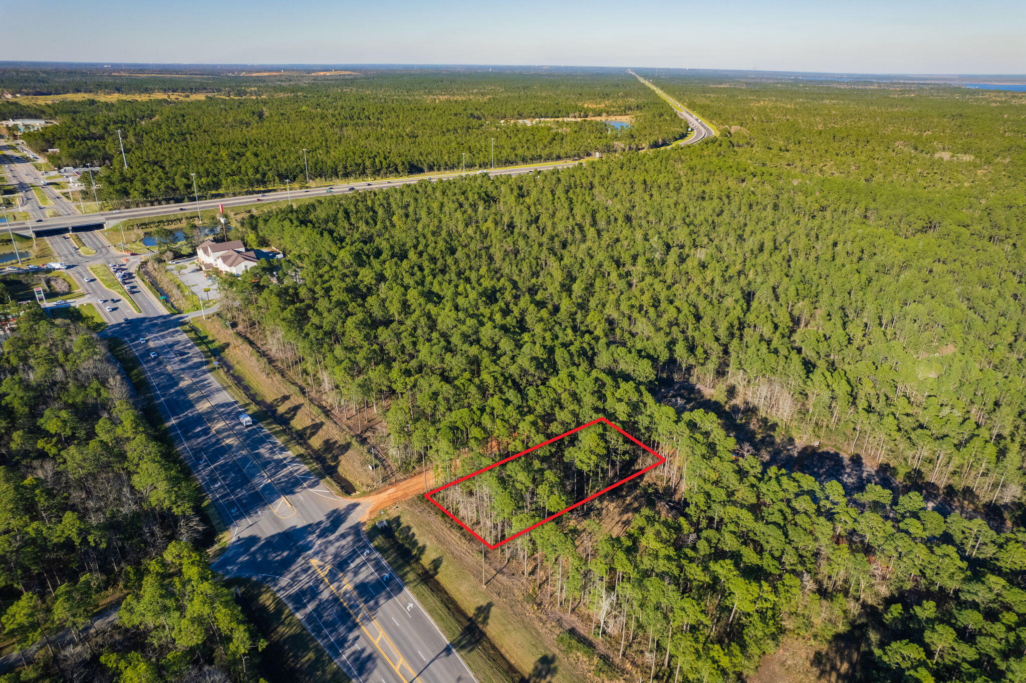 SELLING BOTH PARCELS TOGETHER: 40-1N-28-0090-22400-0010 & 40-1N-28-0090-22400-0240. This unique commercial property consists of two adjoining parcels, creating a larger combined lot with 100 feet of road frontage on a high-visibility corner on Avalon Blvd. With a dedicated turn lane already in place for easy access and close proximity to the I-10 exit, this location offers excellent potential for a variety of business opportunities. Utilities are available at these lots. Zoned commercial and situated in a rural area that is seeing continuous growth and development, this lot provides a great opportunity to establish a business in an emerging market. Don't miss the chance to invest in this expanding area!