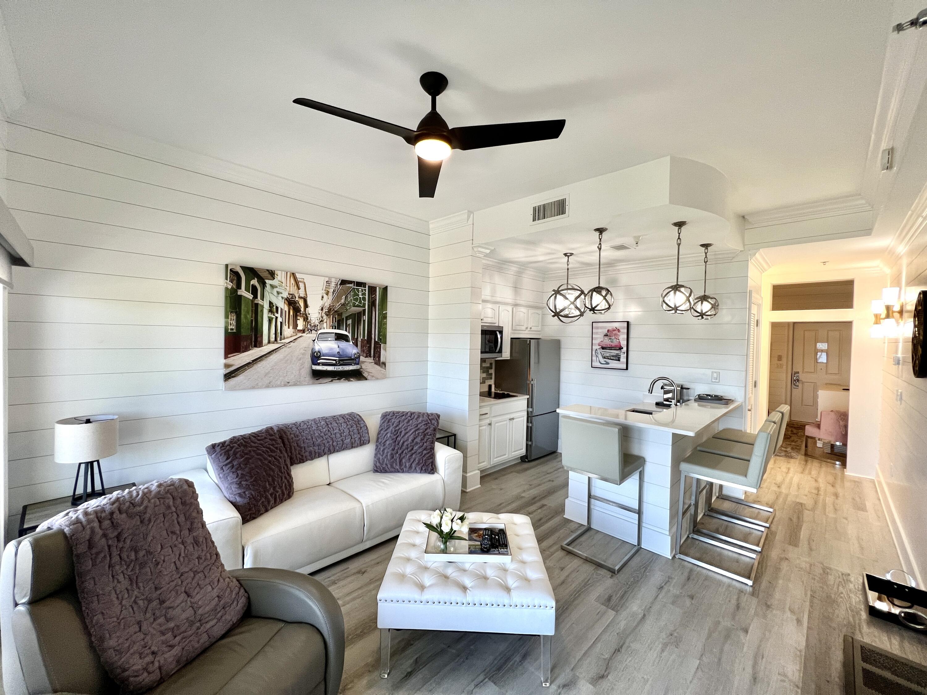 Don't miss the opportunity to acquire a premier, completely renovated, condo on the ground floor of the Carillon Beach Inn. No elevator needed to access your unit from either the lake side or the street side! The entire condominium is embellished with new flooring, shiplap throughout and crown moulding. The bath and kitchen are also newly renovated with the kitchen also featuring all new appliances including refrigerator, dishwasher, glass cooktop and microwave. The living area boasts a striking, high-end Bellini Italian leather couch which easily converts to a pull out sleeper. A distinguishing feature of this condo is the walk-out ground floor to a grassy area which allows immediate access to the resort pool, Lake Carillon, the downtown Carillon area, a short stroll to the beach or walking your pet. These ground floor units rarely come available, there having been no sales of them since 2021. A custom barn door separates the bedroom from the living area, affording privacy not customarily available for units in the Carillon Inn. If you have been looking for an opportunity to get into Carillon this is it---whether you are looking for a second home or an investment with rental potential.