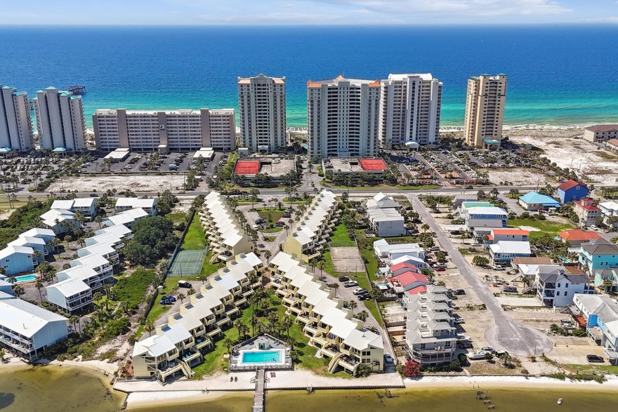 Best of Navarre Beach! Views of the Sound from almost every room and your very own boat slip!! Buena Vida Townhomes offer amenities such as community pool, tennis courts and access to the sound. Three bedrooms, two bathrooms, bonus room, and a loft. The second floor offers an open split floor plan, seamlessly connecting the living, dining and kitchen spaces and opens to a spacious deck, perfect for outdoor relaxation and entertaining. The townhome's location is unbeatable, short walk to the Gulf's white sandy beaches, Navarre Beach Pier, and Navarre Beach Restaurants **Some furniture conveys