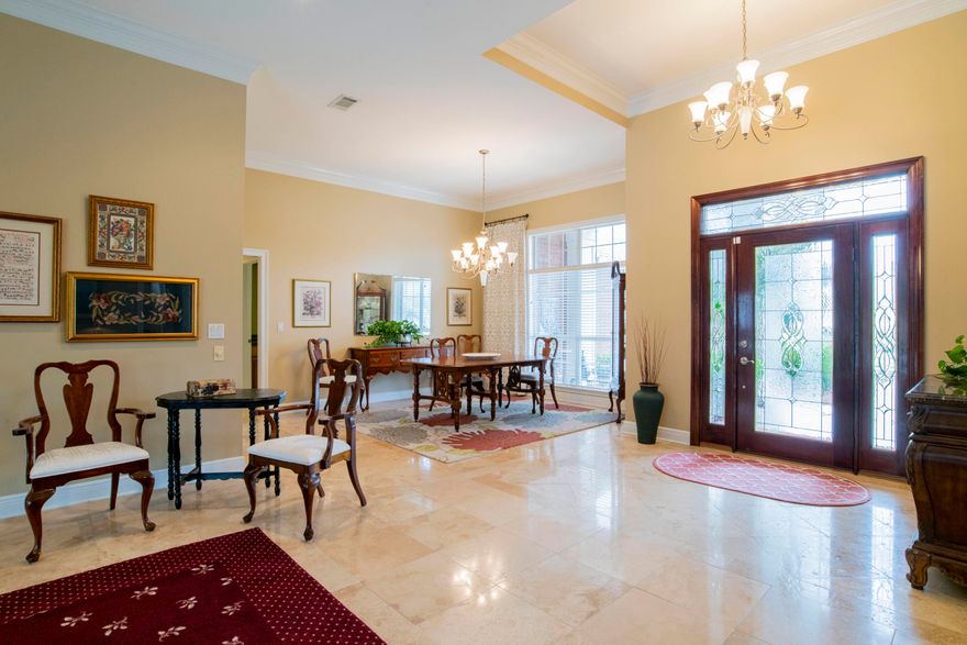 Located in Gulf Breeze in the desirable neighborhood of Grand Pointe, this gorgeous, perfectly maintained home is great for entertaining! You'll enjoy the open floor plan with 12 foot ceilings, screen enclosed saltwater gunite pool with Jacuzzi (removable baby gate), covered lanai and fully fenced back yard. This home has a wonderful flow with a formal living/sitting area, formal dining room and separate living room just off the kitchen. The kitchen comes fully equipped with custom cabinetry, brand new gas cook top, double wall oven, built-in microwave, granite counter tops, island, breakfast bar, breakfast nook and large pantry flowing perfectly into the main living area. The main living room has a gas fireplace, built-in cabinets and french doors opening to the pool area. The spacious,