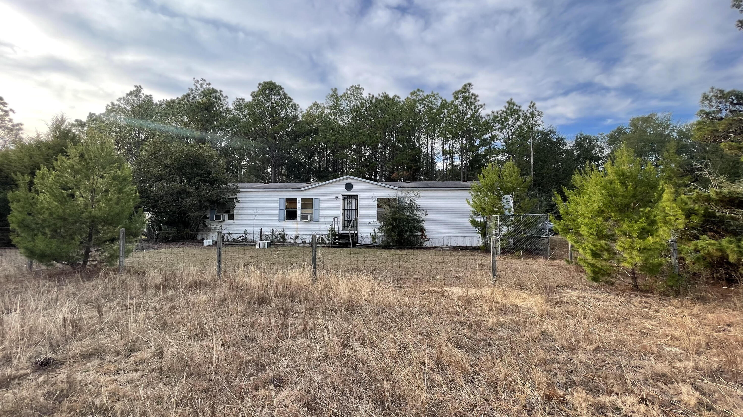 The 5.8 acres surrounding this home are breathtaking. So many possibilities. Build your dream home or fix up the existing home. This is a distressed property and is being sold AS IS. It will be the buyers responsibility to remove any personal items and debris. All measurements are approximate.