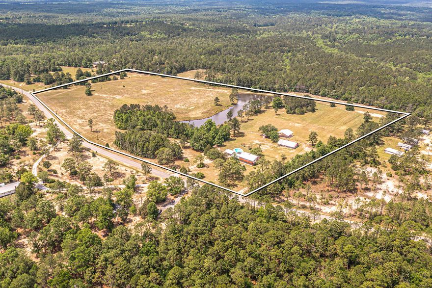 BACK ON THE MARKET!!!! A secluded serene getaway that is actually close to everything! This tranquil location features a large well maintained home on 31 acres, 20x40 pool, 2.5 acre pond (with fish), 40x60 workshop with a furnished  bunkhouse (which can be rented out), storage shed, and a 40x45 pole barn.  This mostly brick/metal roof home has 4 bedrooms, 3 1/2 baths and hosts a large kitchen with plenty of storage and counter space, casual & formal dining areas, two living areas, and a 18x20 rec room w/tons of shelving/storage! The primary suite is oversized with plenty of closet space & tiled shower. Enjoy outstanding views with walkout balconies from 3 different rooms upstairs.