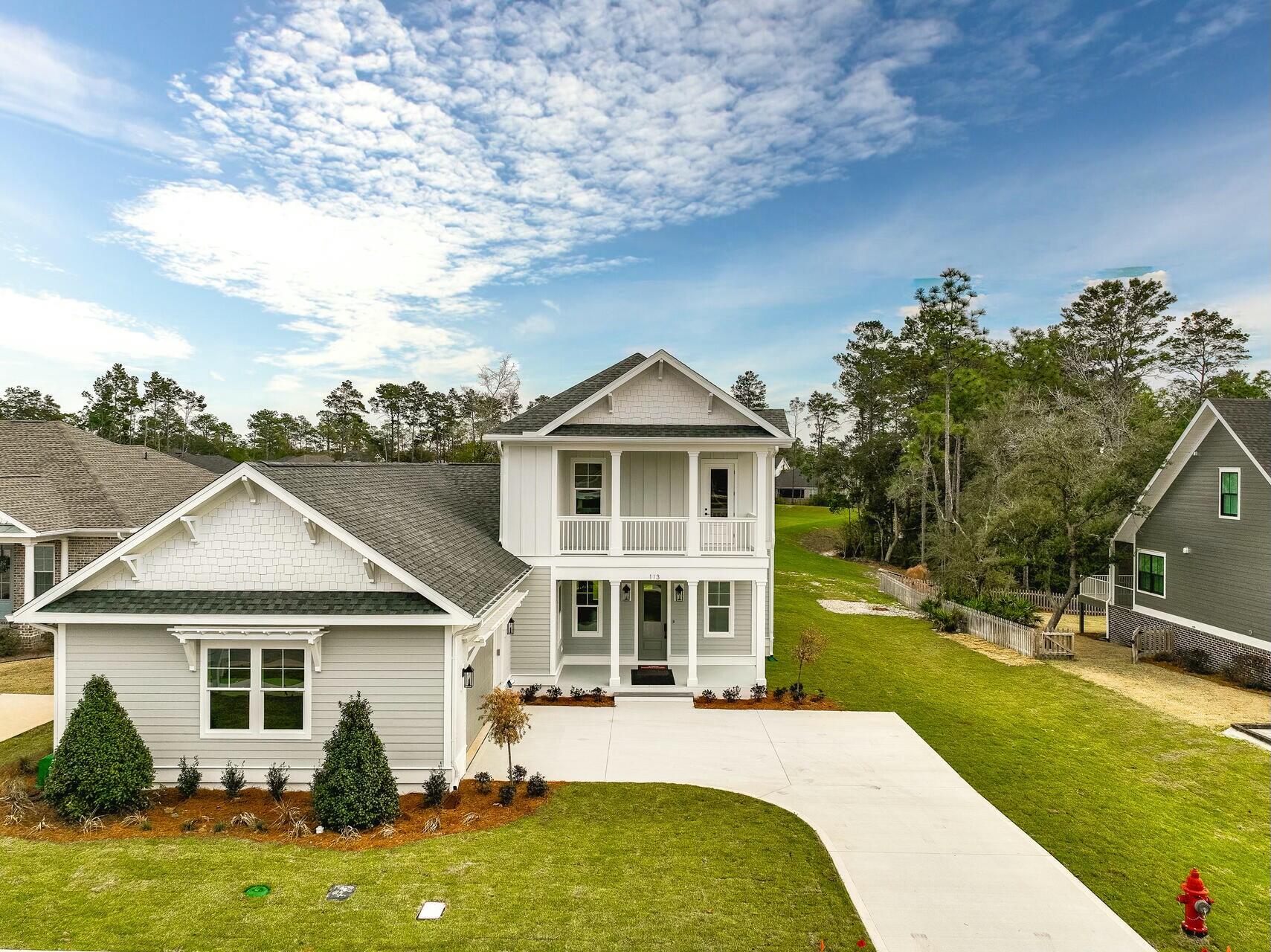 This stunning 4-bedroom, 3.5-bath home is nestled on a private perimeter lot in the highly sought-after Deer Moss Creek, a master-planned community offering a host of fantastic amenities. Enjoy the expansive natural backyard and ample space for relaxation or outdoor entertaining. Inside, you're greeted by a spacious living area with built-in shelving, luxury vinyl flooring, and an open-concept layout that seamlessly flows into the dining area and large kitchen. The kitchen is a chef's dream, featuring a double oven, quartz countertops, and a large island perfect for meal prep and gatherings. The master suite, located on the first floor, provides a tranquil retreat, along with an additional bedroom on first level ... for convenience. Upstairs, you'll find two more bedrooms and a versatile flex space that could serve as an office, playroom, game-room or home gym. For added charm and relaxation, the exterior features accessible balconies not only on the front but also at the rear of the home, offering beautiful views of the surrounding area. The Deer Moss Creek community enhances your lifestyle with a pool, basketball court, playground, clubhouse, and walking trails. With privacy, modern touches, and ample space for family living, this home is truly a gem.