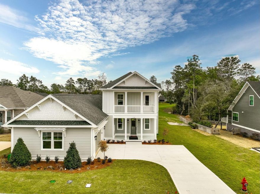 This stunning 4-bedroom, 3.5-bath home is nestled on a private perimeter lot in the highly sought-after Deer Moss Creek, a master-planned community offering a host of fantastic amenities. Enjoy the expansive natural backyard and ample space for relaxation or outdoor entertaining. Inside, you're greeted by a spacious living area with built-in shelving, luxury vinyl flooring, and an open-concept layout that seamlessly flows into the dining area and large kitchen. The kitchen is a chef's dream, featuring a double oven, quartz countertops, and a large island perfect for meal prep and gatherings. The master suite, located on the first floor, provides a tranquil retreat, along with an additional bedroom on first level ...  for convenience. Upstairs, you'll find two more bedrooms and a versatile flex space that could serve as an office, playroom, game-room or home gym. For added charm and relaxation, the exterior features accessible balconies not only on the front but also at the rear of the home, offering beautiful views of the surrounding area. The Deer Moss Creek community enhances your lifestyle with a pool, basketball court, playground, clubhouse, and walking trails. With privacy, modern touches, and ample space for family living, this home is truly a gem.