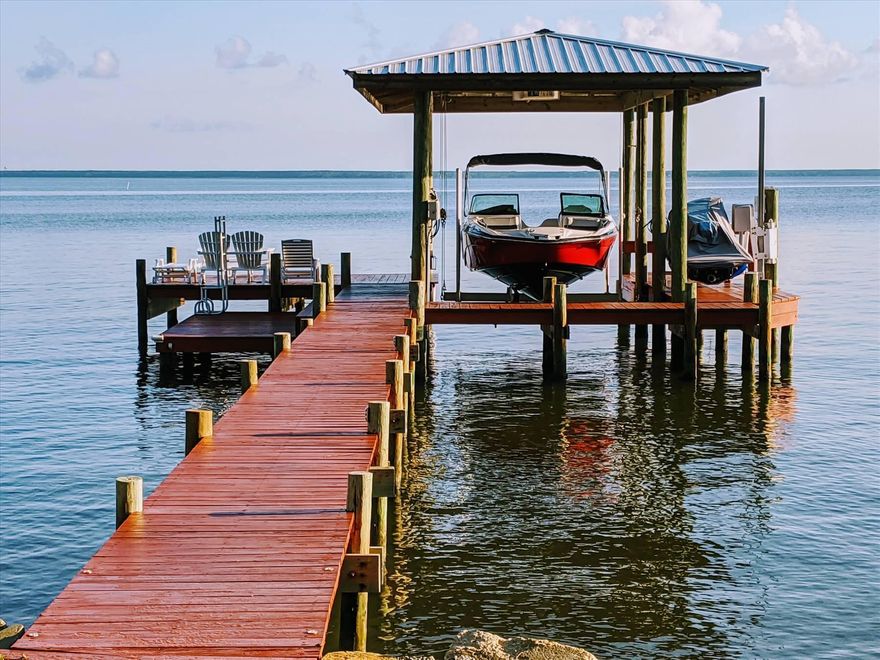 Truly Unique - Water lovers paradise, cozy, high and dry, and watch sunsets and sunrises from home Great home for avid boaters and nature lovers. Cozy home with fireplace, granite gathering table, and plenty of space for guests. Safe and well-maintained home. NEW: Metal Roof and Concrete Pilings! All new windows, doors, and many upgrades and the home has a very functional design so it feels bigger than it is. A dock with beautiful boathouse will hold up to a 30 ft boat and has a 7,500+ pound boat lift and a jet ski lift. Water depth at the dock is 3 to 4 feet. Wrap around deck with outdoor shower, deep fresh well water. Electric bill $100 average. A scenic 4-mile open view across the bay is an oasis of peace, quiet, and nature with Osprey, Herons, and Dolphins in the backyard.