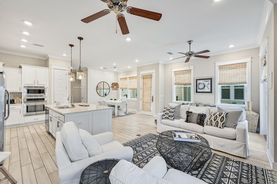 Ideally designed and curated for the savvy investor or vacation-home owner, this Prominence townhome features three bedrooms and 2 1/2 baths with a 2-car garage. This home sits on a perfectly positioned premium lot with close proximity to the beach and backs up to HOA owned green space. Featuring the largest floor plan in the Prominence community with 1747 sq. feet and a two car garage, this spacious and inviting floor plan features a powder bath on the main level, timeless wood-look porcelain tile flooring throughout and a gourmet kitchen with a large island, stylish stainless range hood, granite countertops, stainless steel-gas appliances, and beautiful tile backsplash. Upstairs, the main suite boasts a luxurious private ensuite bath with double sink vanity and tile shower, while 2 guest