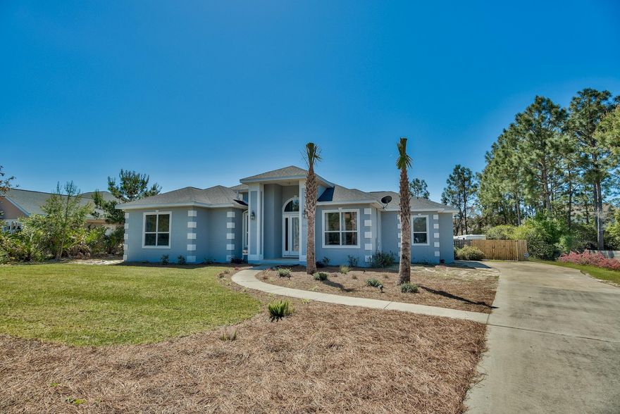 This charming one level home is located opposite the Santa Rosa Beach Golf Club and is situated on more than a 1/2 acre lot, within a 1/2 mile from the beautiful white sand beaches of the Gulf of Mexico. Enter the home to be greeted by an open floor plan featuring 10 foot ceilings, tile flooring, a formal dining room, spacious kitchen and a four season porch. The kitchen features a new Bosch Gas stove and stainless steel French door refrigerator and a large pantry. There is a large master suite with bedroom featuring a Trey ceiling and walk in closet and bathroom with a walk in shower, large jetted soaking tub and his and hers vanities. There are two additional bedrooms and a guest bathroom. The four season porch leads onto a private deck overlooking the large fully fenced backyard.