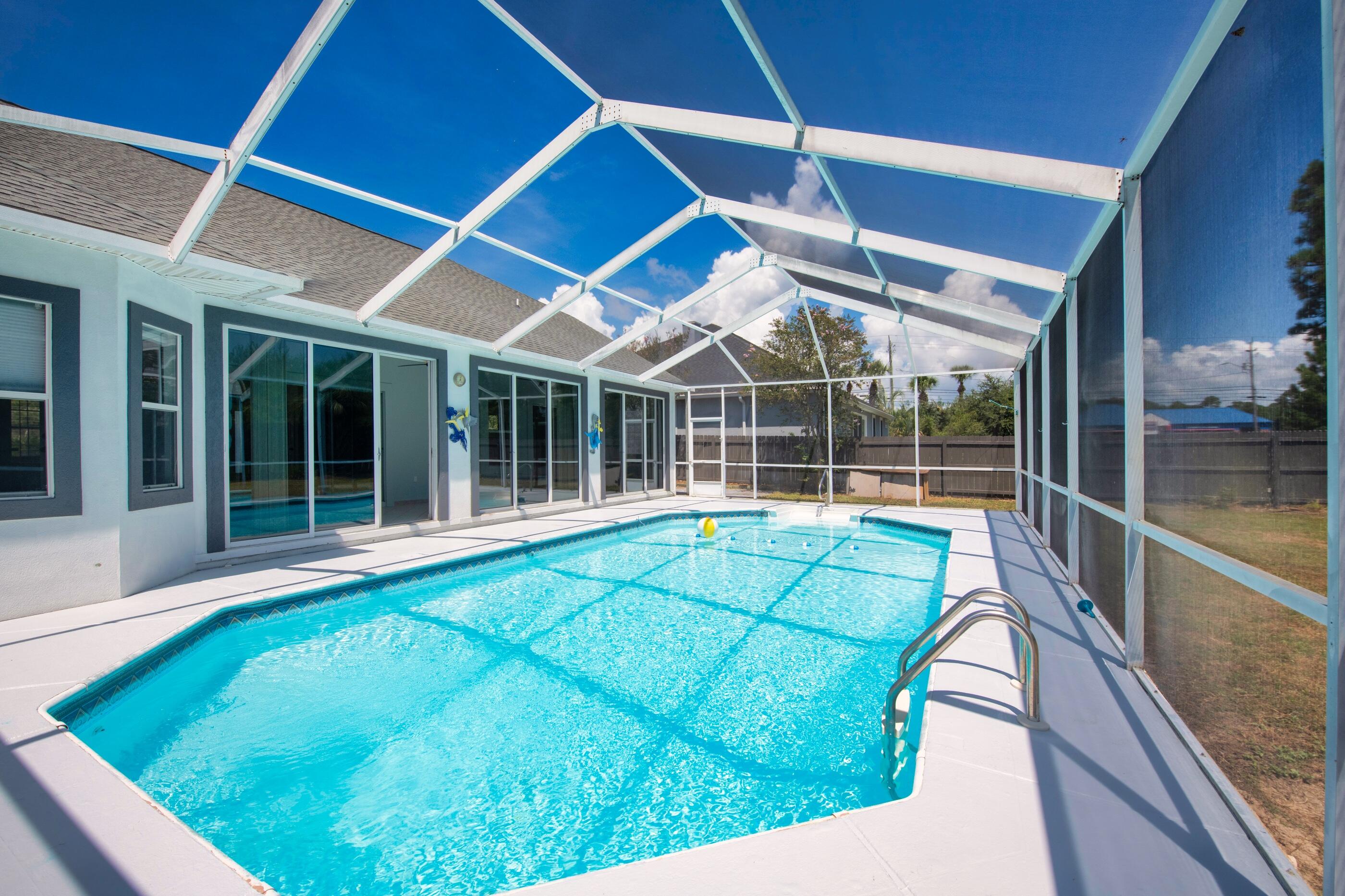 Seller offering 10k towards buyer's loan rate reduction or other closing costs! New Virtual tour available. Renovated Pool Home in East Navarre Waterfront Community. Enjoy the sand and waves at the community waterfront beach. This move in ready home features a Screened in Pool, renovated kitchen and bathrooms with beautiful new marble countertops, tall vaulted ceilings, fireplace and luxury vinyl plank throughout the home. The large heated and cooled florida room can be used for an office, sitting room, or play room overlooking the pool. The master bedroom is spacious and the master bathroom features two vanities, a walk in closet, walk in shower and jacuzzi tub. This home has easy access to hurlburt and is 5 minutes from Navarre Beach. Roof 2019 HVAC 2016. New Pool liner with offer!