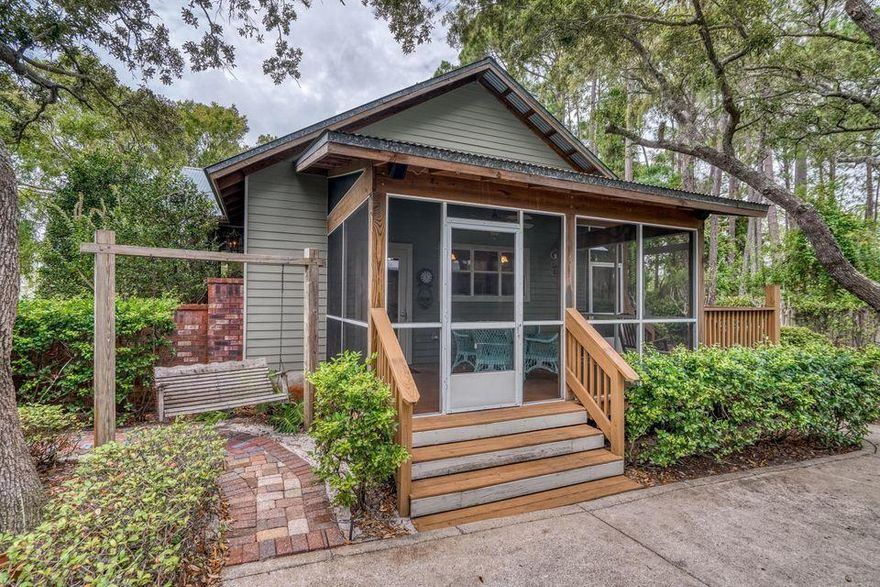 Situated on a corner lot, the home has an open floor plan with a spacious living room, kitchen and dining area all within view of the fireplace. Above the garage are the additional living quarters for guests and in laws.  The screened in porch overlooks the serene and private pool deck.