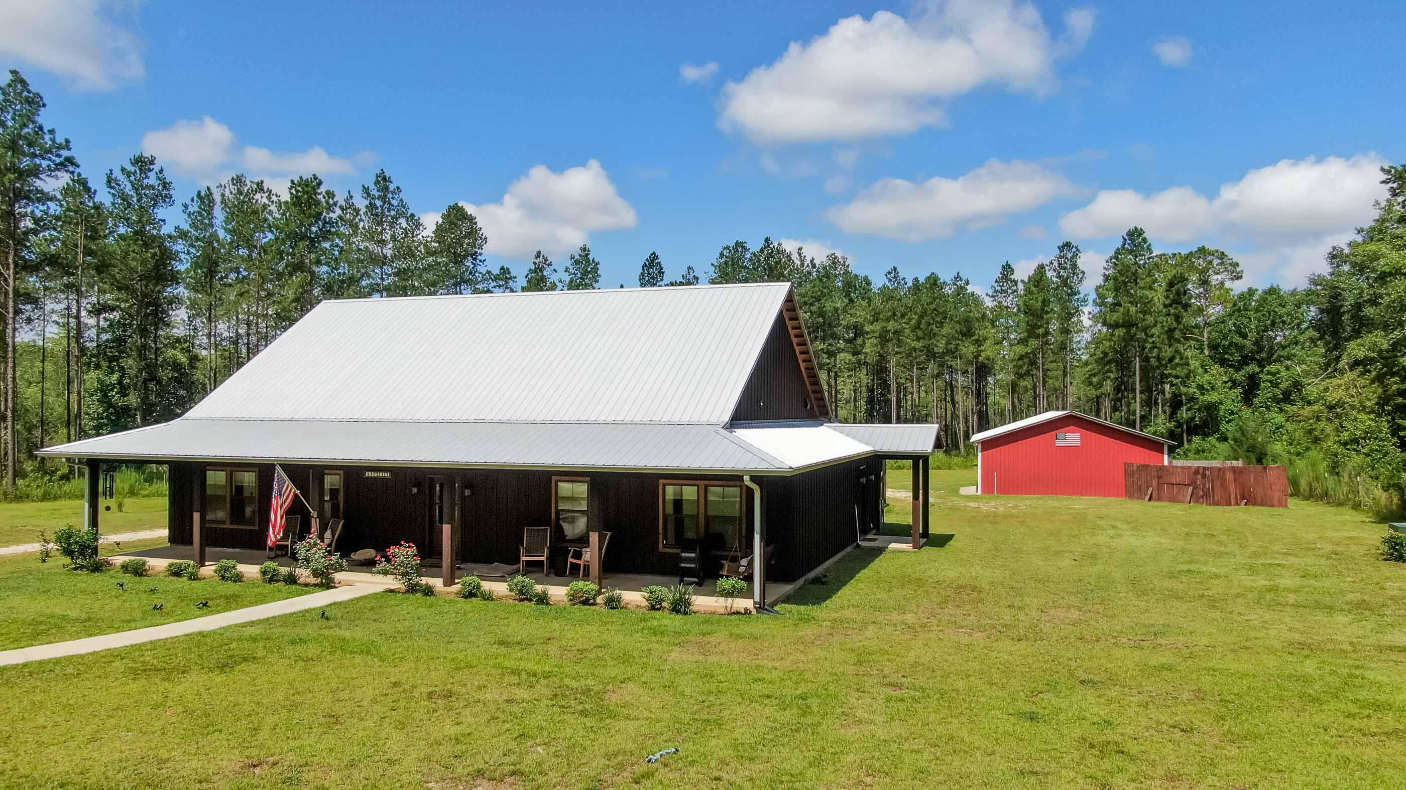 Spectacular nearly new pool home, nestled on 10+ acres in the heart of Bonifay. Superior construction with top tier finishes only, such as quartz, solid wood cabinets, marble and hardwood floors - even a built-in generator and a dehumidifier. Split floor plan offers 3 bedrooms, a sizable office, plus a bonus room (storage/exercise/etc). Attention to the details makes this home special, as seen with the shiplap accent walls and the wood coffered ceiling. The master suite boasts a huge walk-in closet, double vanity and oversized classic marble shower. Outdoor entertaining is easy with a back porch, built in grill, enclosed with a 16x32 gunite pool with tanning ledge + hot tub. The detached garage/barn fits 2 vehicles plus all of your toys. Property is 5 minutes to downtown Bonifay and