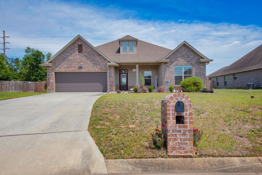 Welcome Home.   Located in the Spencer Ridge West subdivision and within a half mile to shopping, and eateries, this home has it all.  You are welcomed by the covered front porch where you can sit and enjoy your morning cup of coffee or a cold beverage.  This home has tile floors throughout. and neutral paint colors.  The foyer leads to the open floor plan of the spacious living room with an electric fireplace as the focal point.  The kitchen features a granite breakfast bar with seating for 4-5.  The stainless appliances in the kitchen all convey. There are two pantries  for lots of extra storage.  The 2nd pantry is located in the laundry room.  The master bedroom has trayed ceilings and plenty of room for all your furniture.  The master bathroom features granite counter tops with double