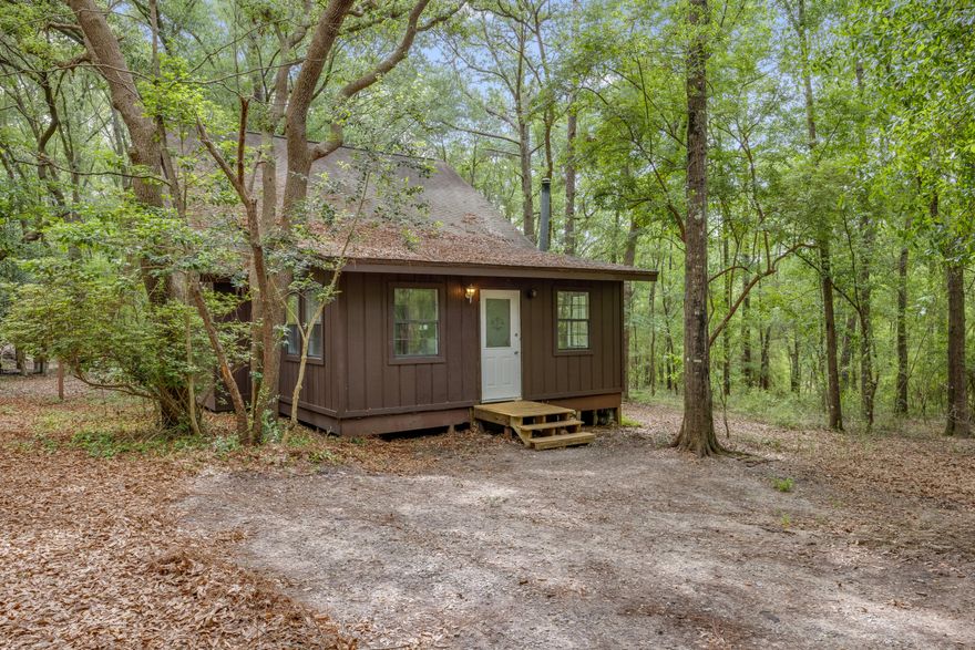 Welcome to country living in this cozy 3-bedroom, 2-bathroom cabin-style home. Boasting a warm and inviting living space, this charming retreat welcomes you with a large, open living area, an abundance of natural light, and a cozy fireplace perfect for chilly evenings. The main floor contains the master suite with two additional bedrooms and an adjoining Jack and Jill bathroom upstairs. Outside, the expansive deck beckons you to unwind amidst the beauty of the outdoors, offering the perfect setting for entertaining or simply enjoying the peaceful surroundings. Conveniently located minutes from Interstate 10, yet secluded, this enchanting woodland retreat promises a lifestyle of tranquility and natural beauty. Property has a brand new HVAC.
