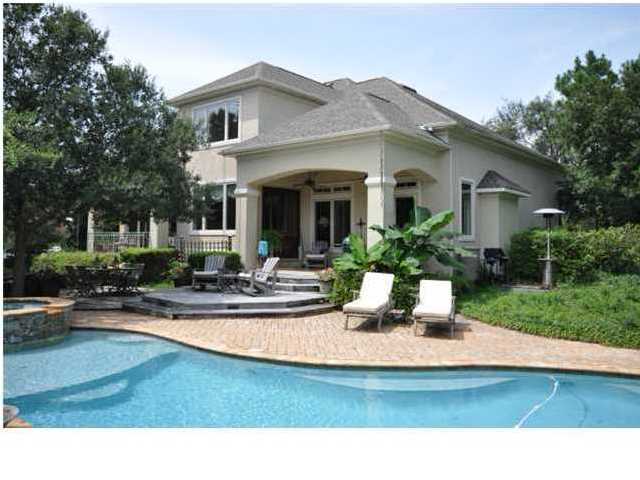 Absolutely gorgeous custom home situated on a large homesite with 175 feet of deep water frontage on Indian Bayou. Mature landscaping and a canopy of live oaks offer a measure of privacy from the homes across the bayou without loosing the view of the water. Meticulously designed with gracious outdoor entertaining in mind with a covered patio, spacious brick paver pool deck, and several terraced decks offering numerous seating arrangements. Family and guests will love relaxing by the pool...and for the boating enthusiast, the dock has an existing boat lift and has accommodated a 34 foot boat.An impressive entry opens to a two story foyer, with a sweeping, curved stairway leading to the second level. The foyer is very generously sized and currently houses a baby grand piano. To the right